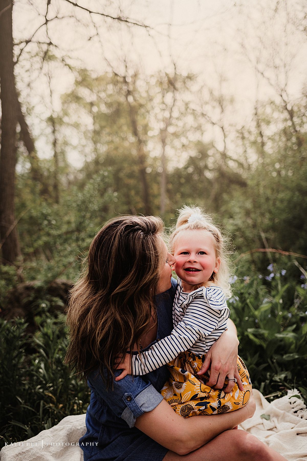 Joyful laughter captured in natural light with blooming flowers nearby.