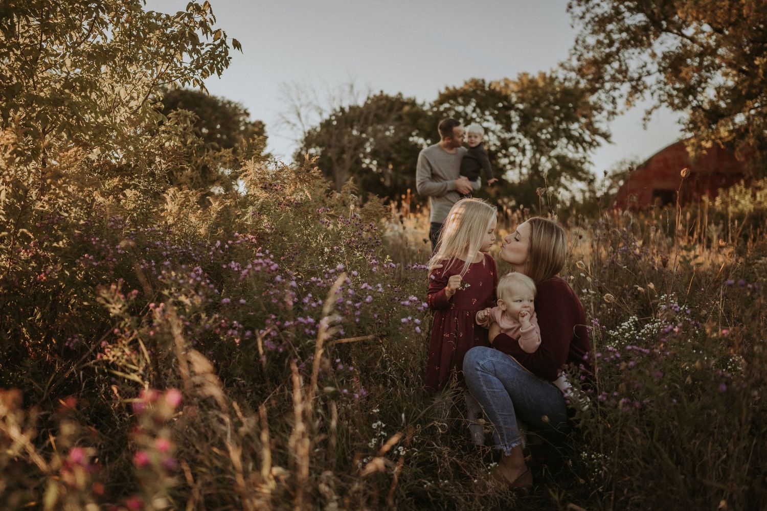 Family lifestyle portrait session in a rustic field during sunset.