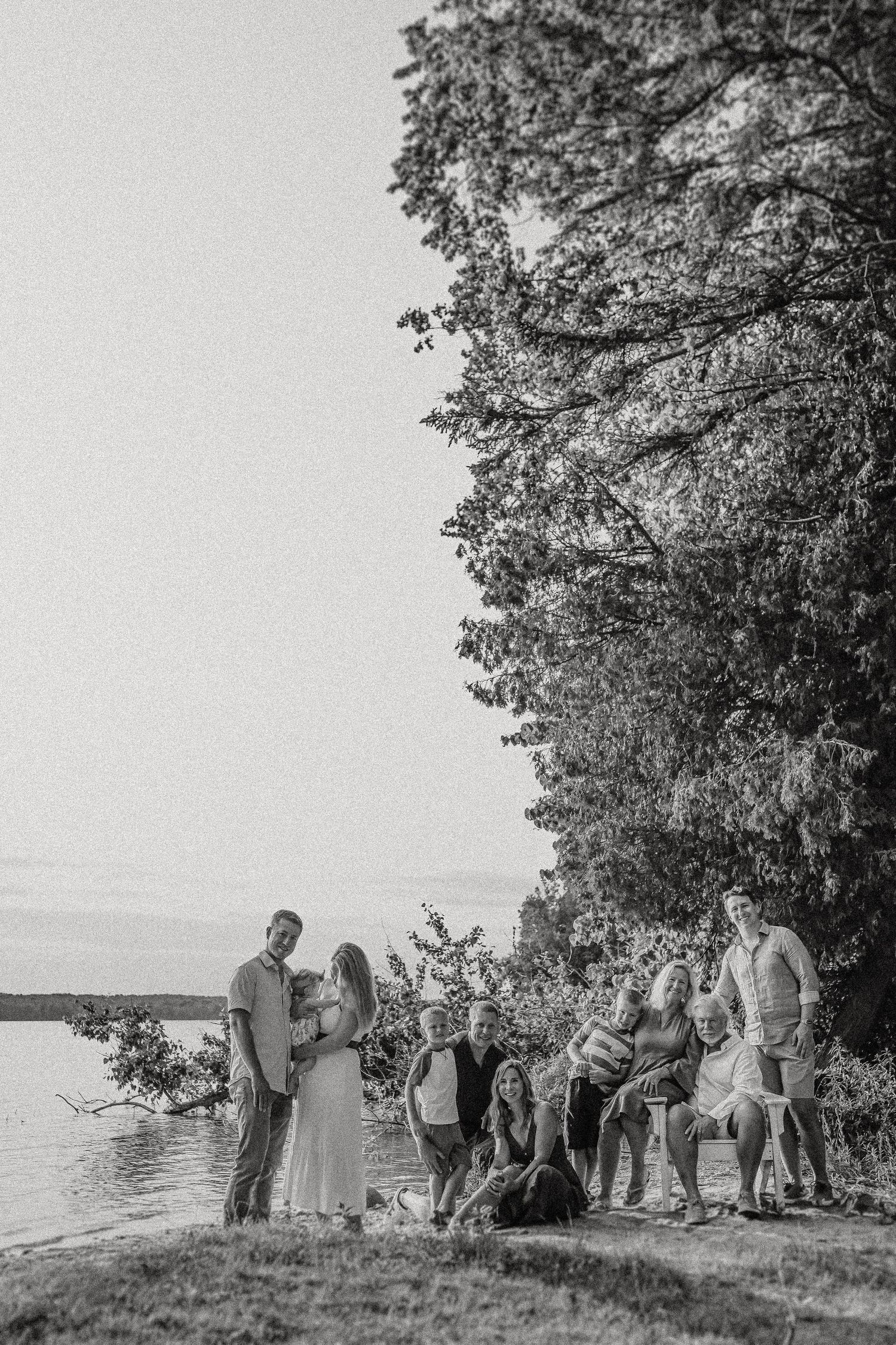 Black and white photo of wedding ceremony group by lakeside.