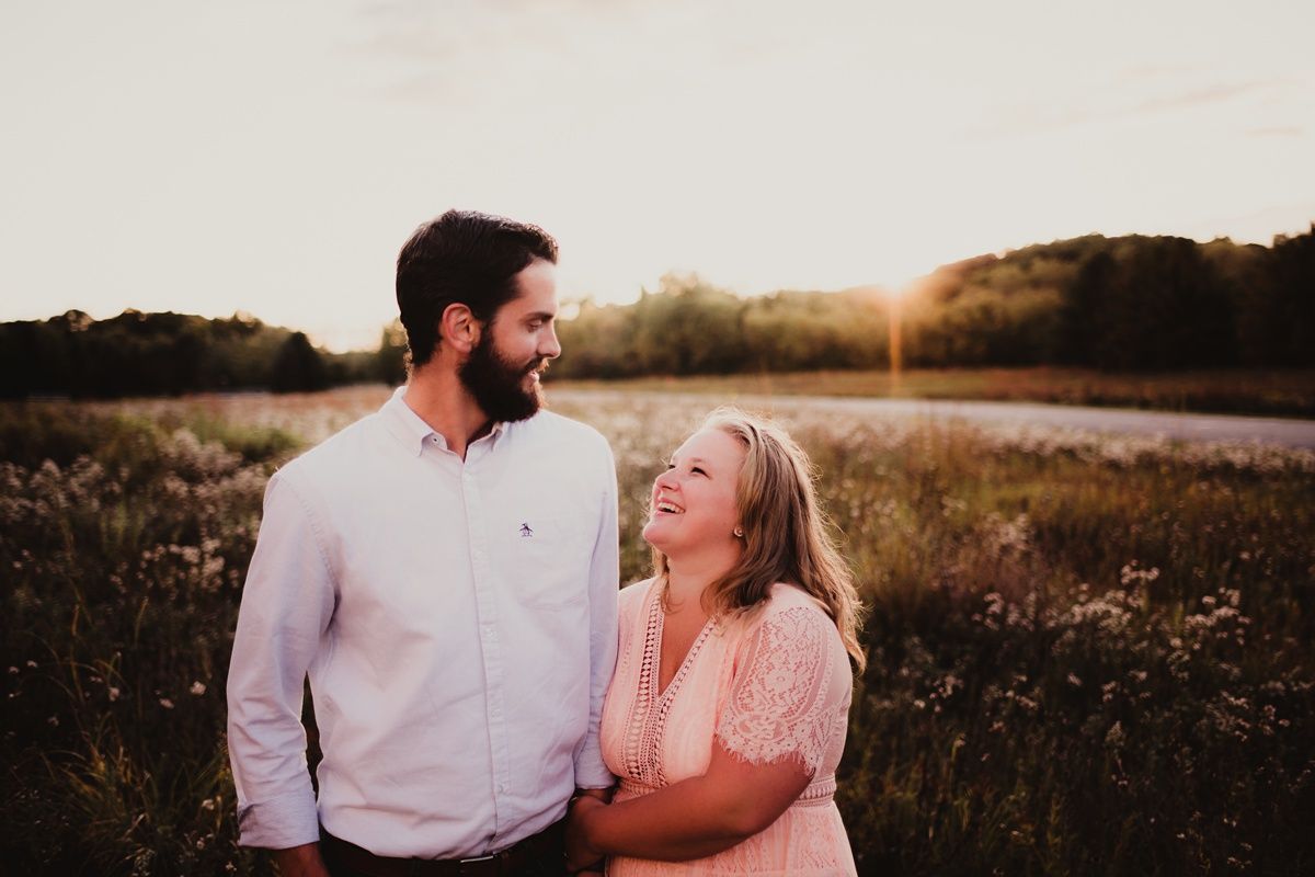 Romantic sunset portrait in a blooming meadow with golden hour lighting.