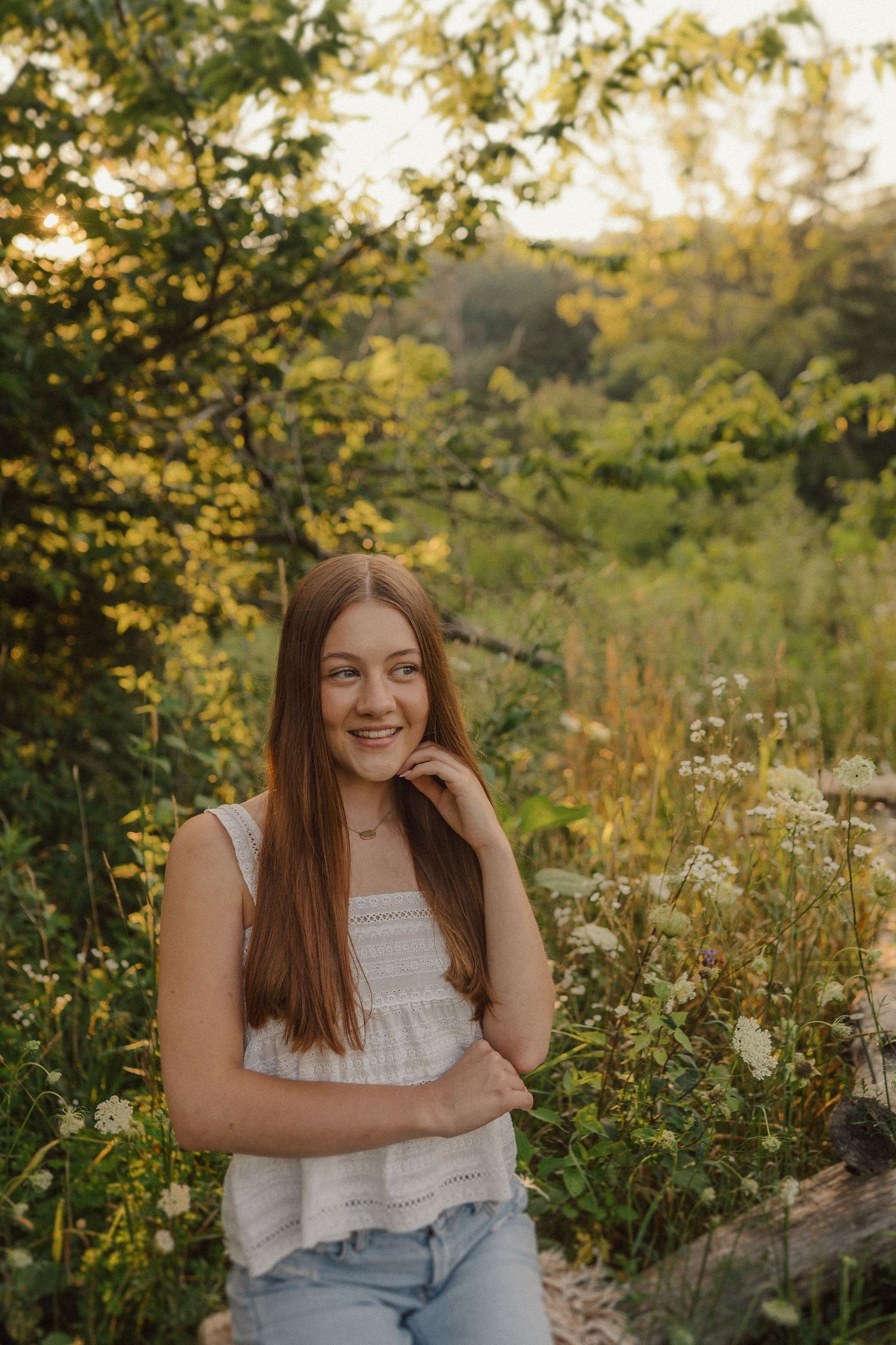 A casual summer portrait session in a wildflower field during golden hour.