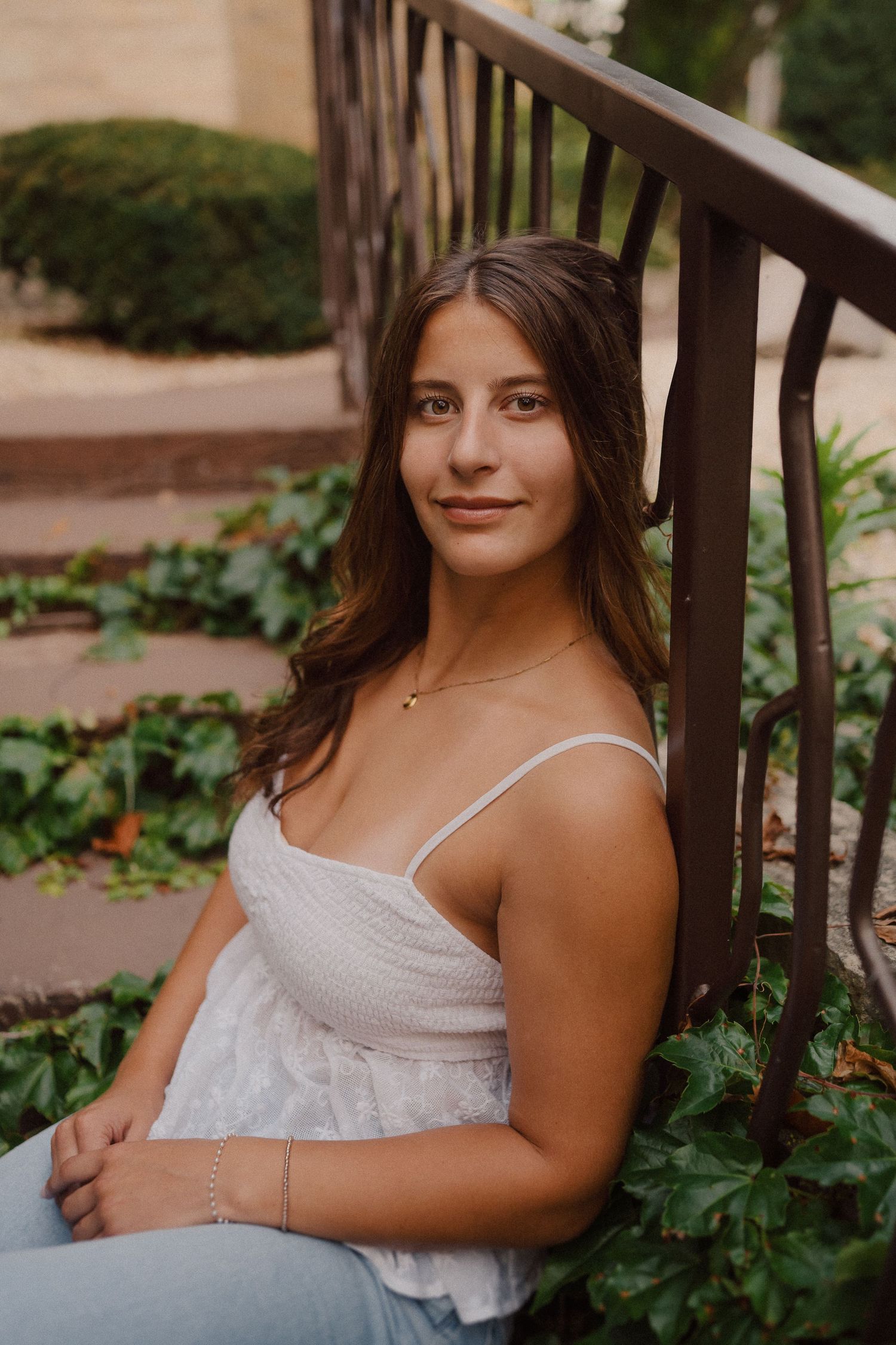 Casual outdoor portrait series on brick steps with ivy and natural landscaping.