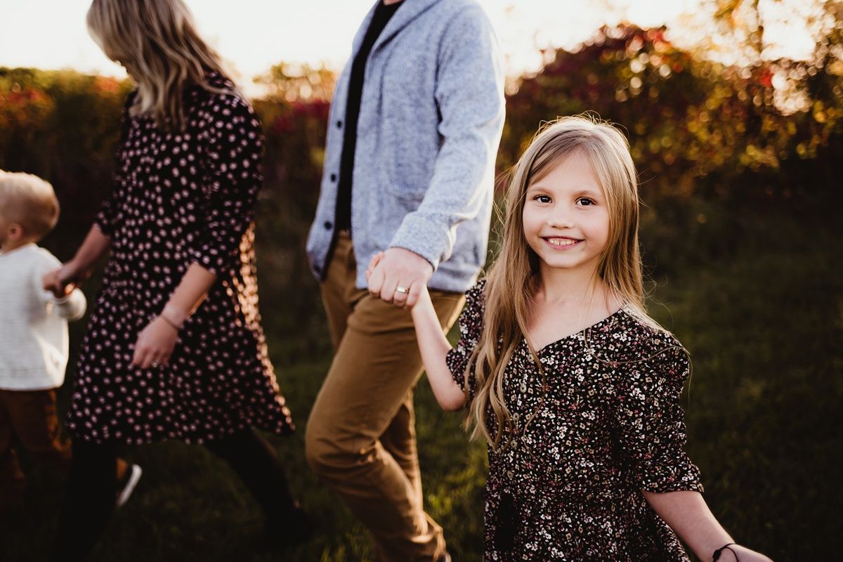 A magical sunset outdoor photo session with a floral dress and natural lighting.
