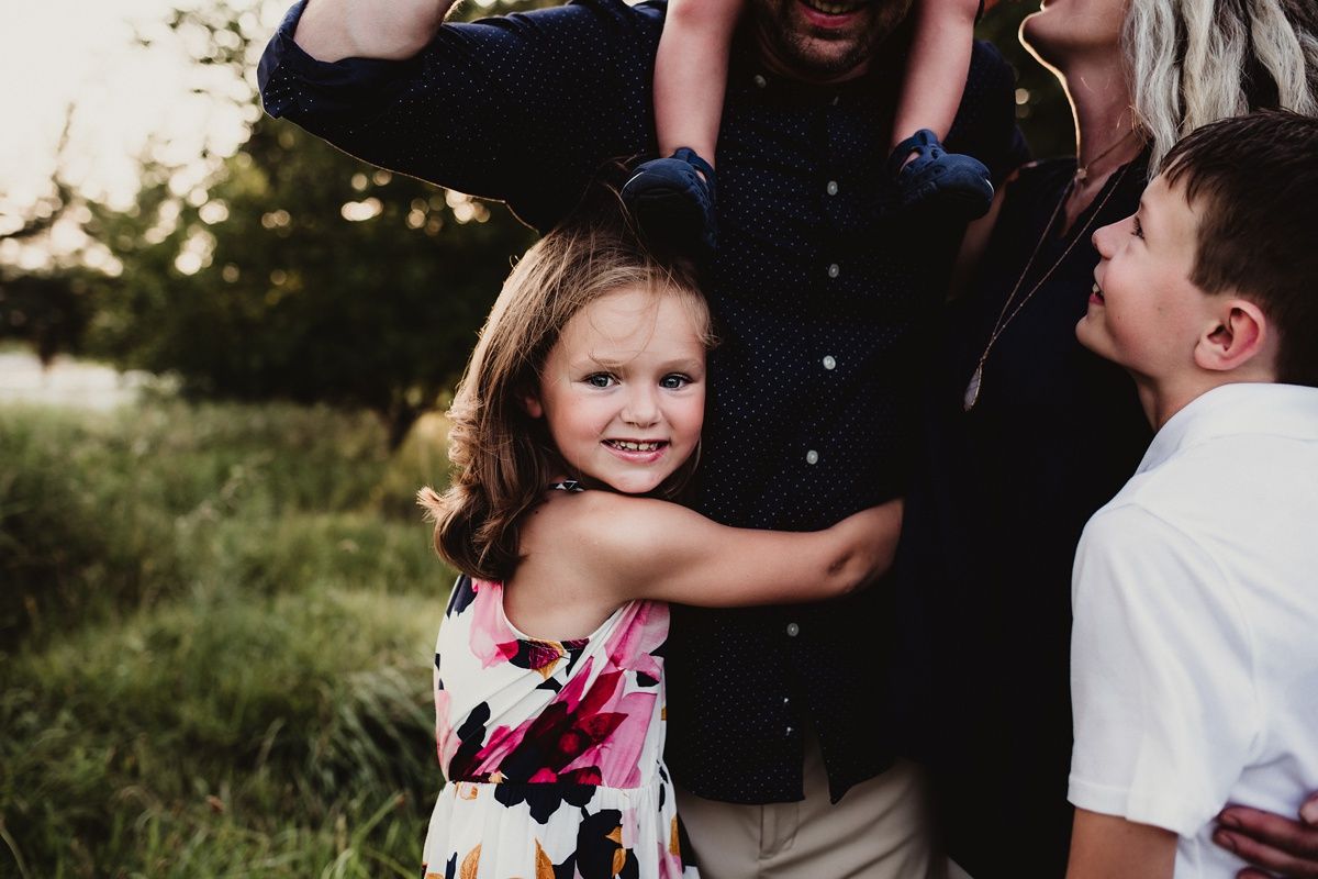 A joyful family moment captured outdoors in natural lighting.