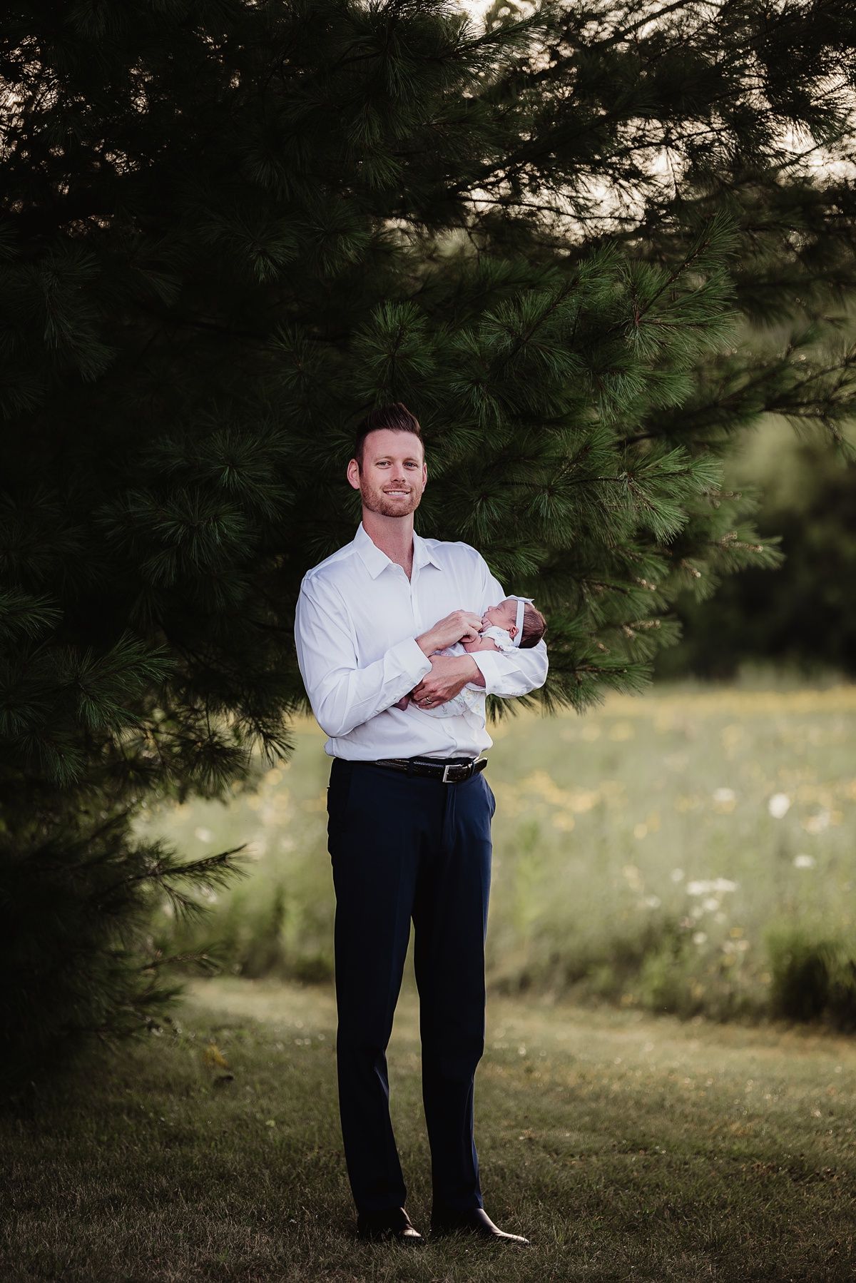 Elegant portrait in a wooded setting with soft natural lighting.