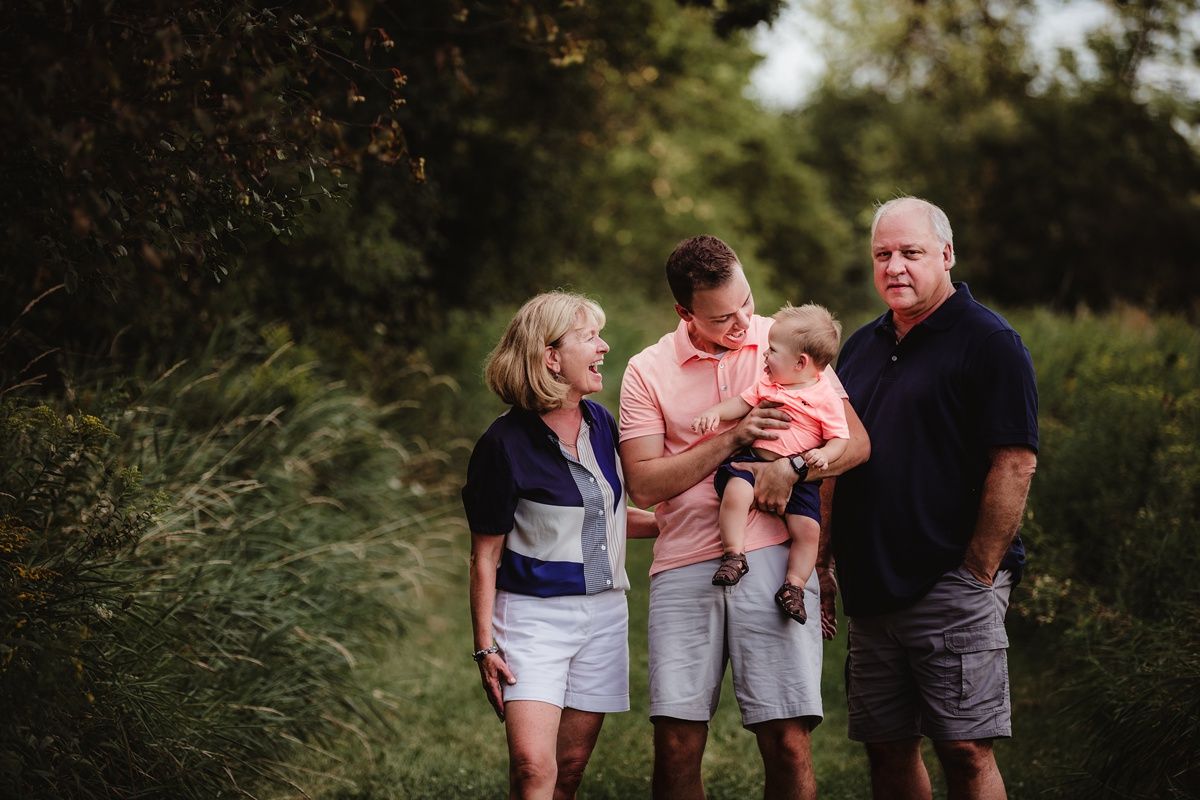 Multi-generational family enjoying a casual outdoor photo session.