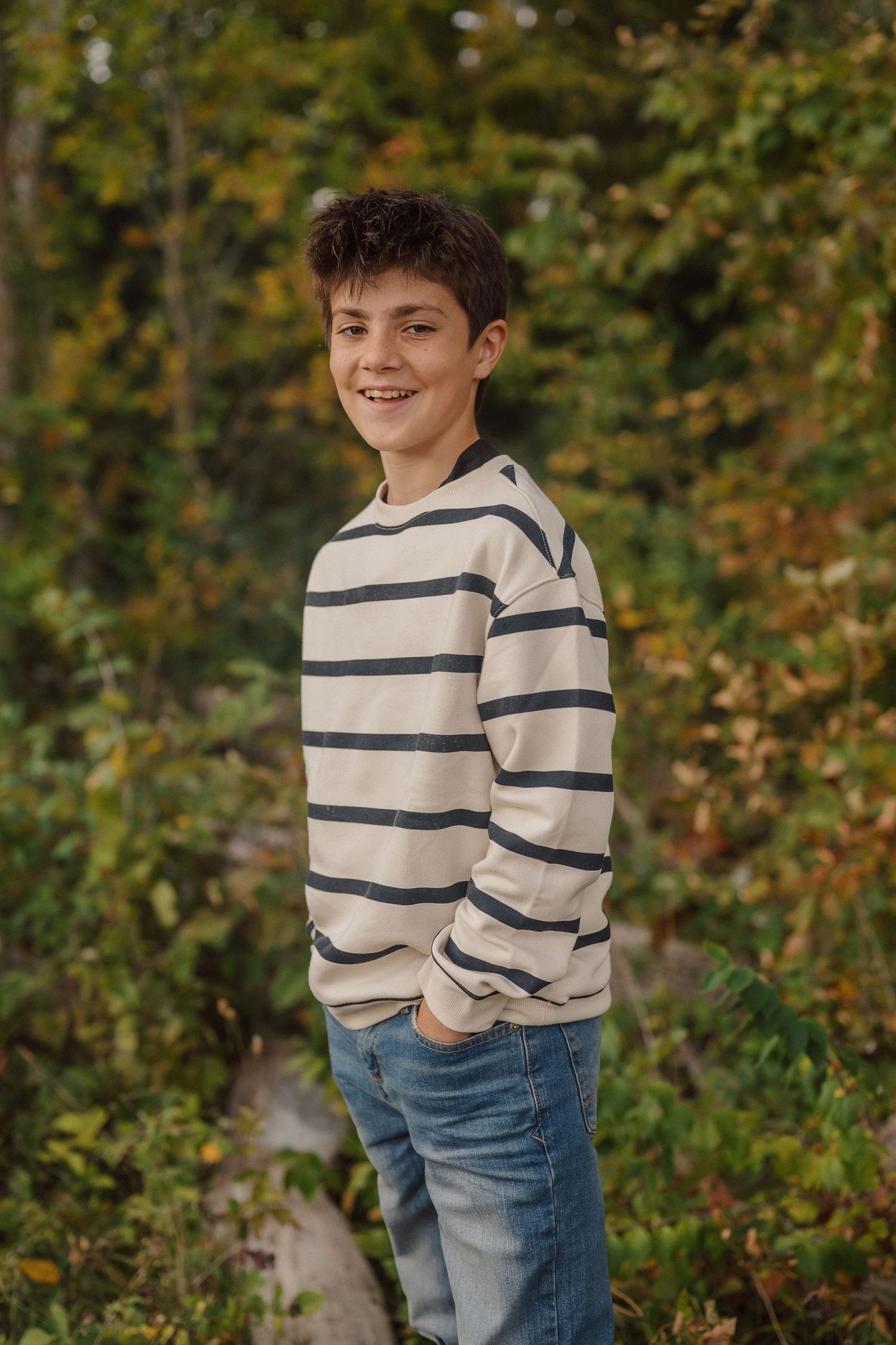 A sequence of casual outdoor portraits showing playful poses against a natural autumn background with foliage.