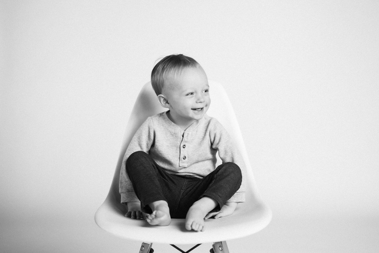 Series of black and white portraits showing natural candid moments and genuine laughter in casual setting.