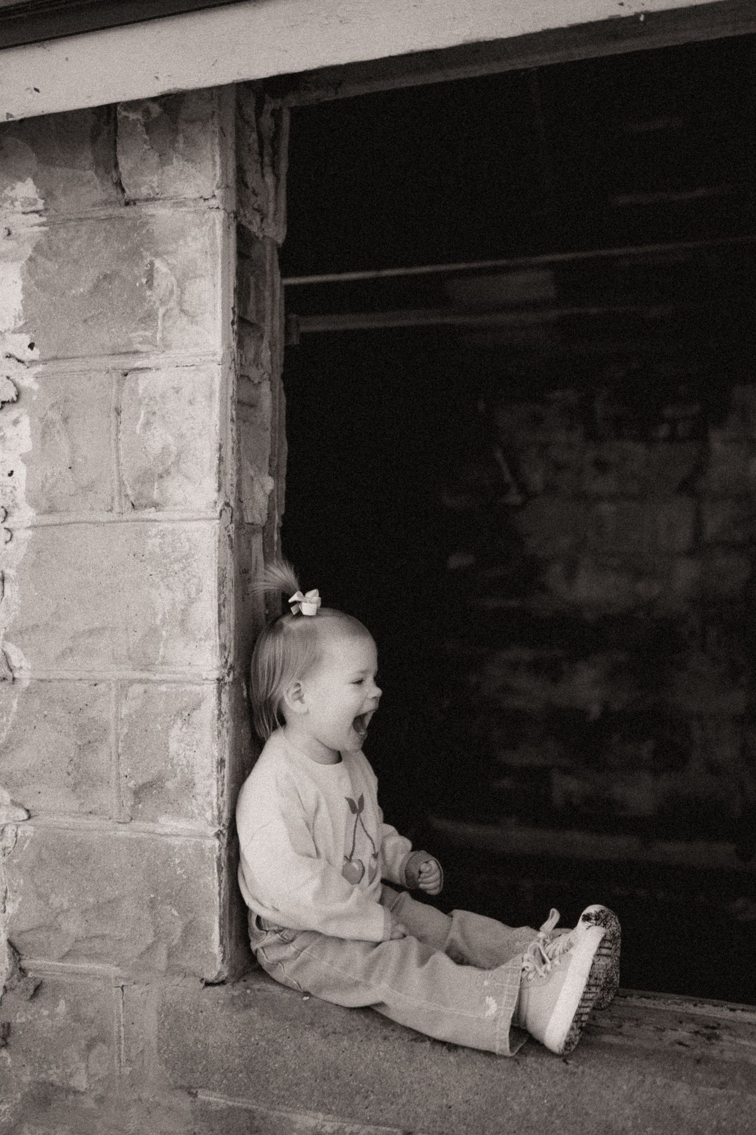 A sequence of candid moments captured through a basement window frame.