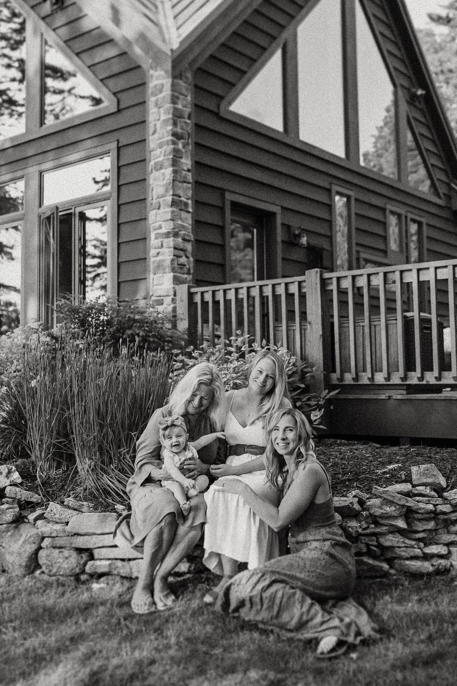 A black and white photo showing a peaceful moment outside a modern cabin.