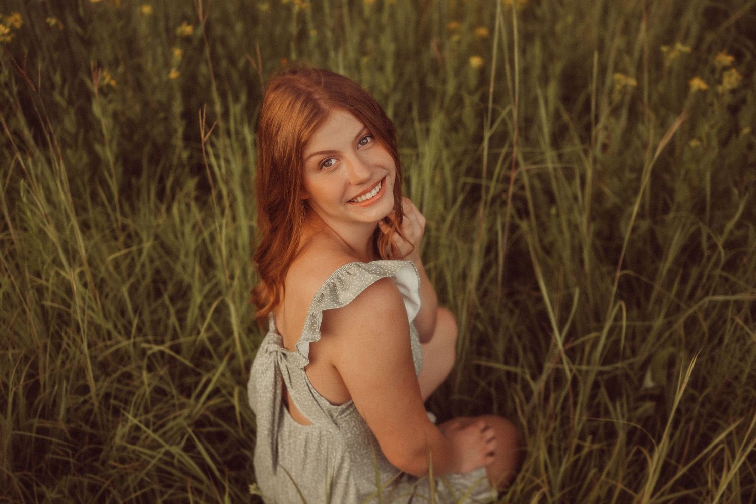 Candid portrait in a golden meadow during magic hour.