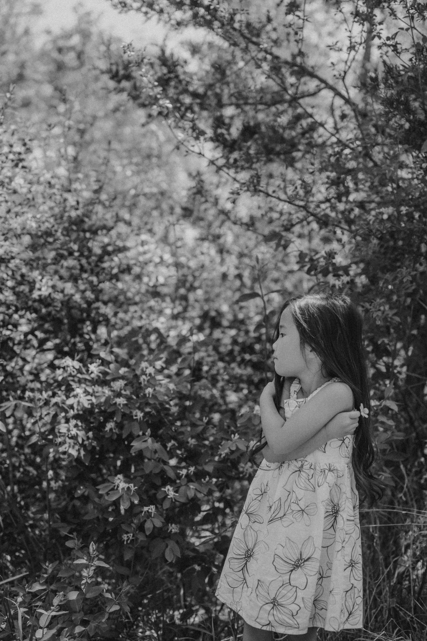 A black and white photograph capturing a contemplative moment in nature.