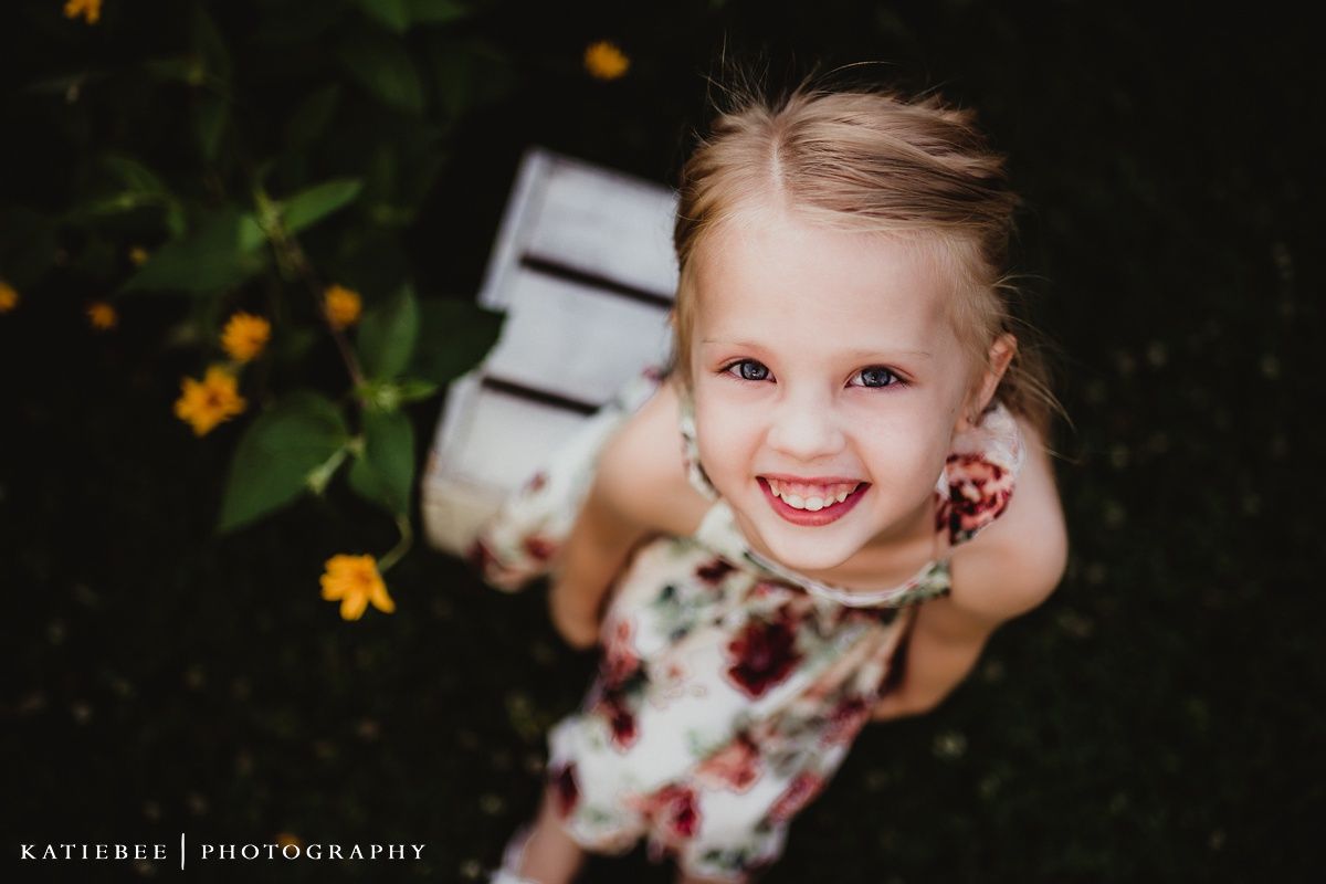 Looking up at a joyful scene with yellow flowers against a dark background.