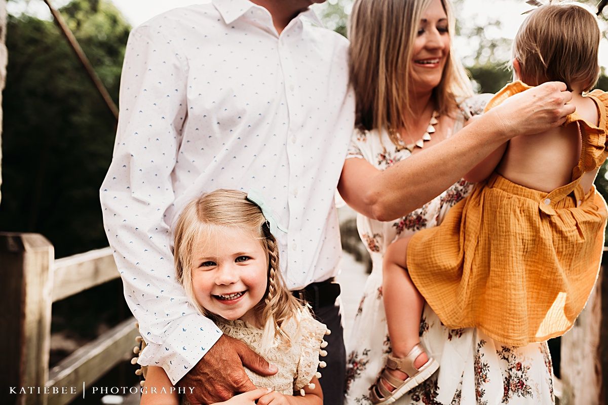 Candid family portrait showing genuine happiness and connection outdoors.