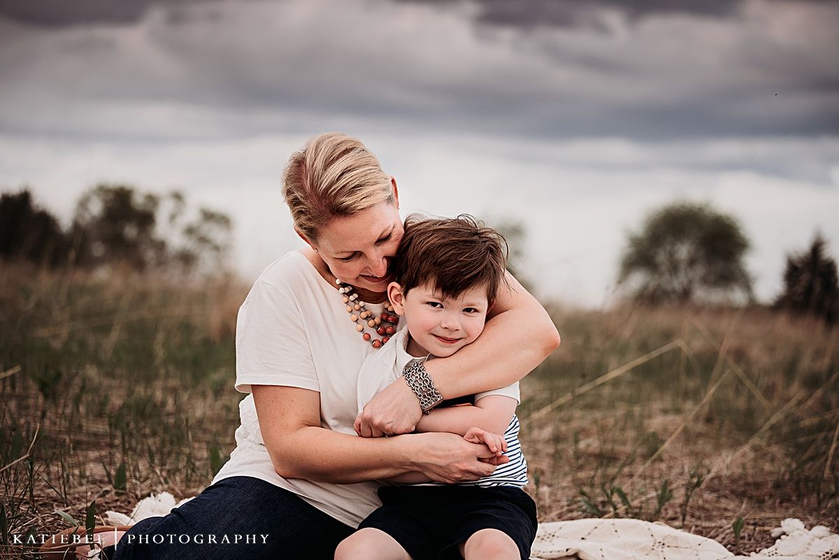 A tender embrace captured during an outdoor family photo session at dusk.