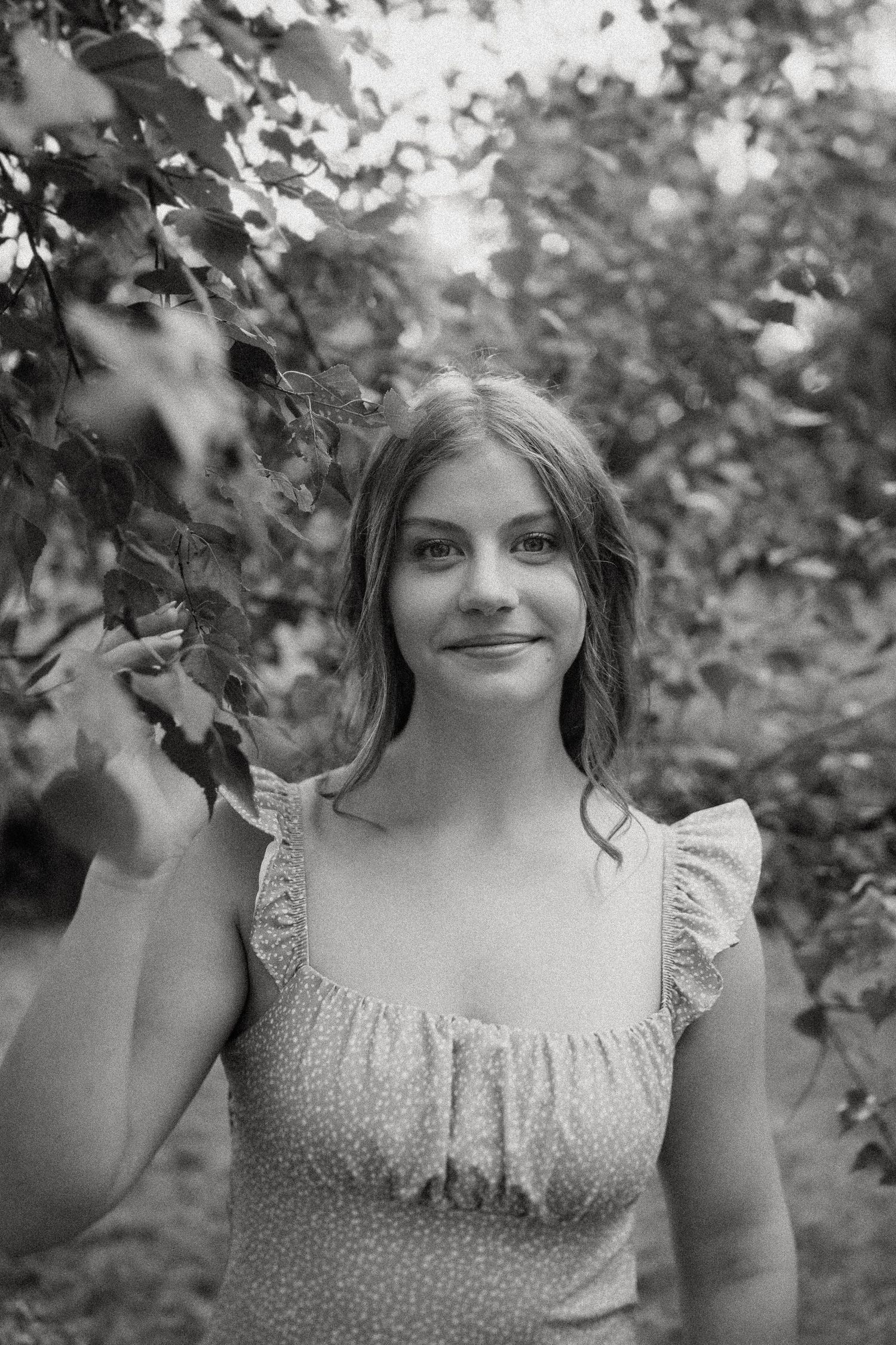 Classic black and white close-up portrait featuring a vintage-style summer dress.