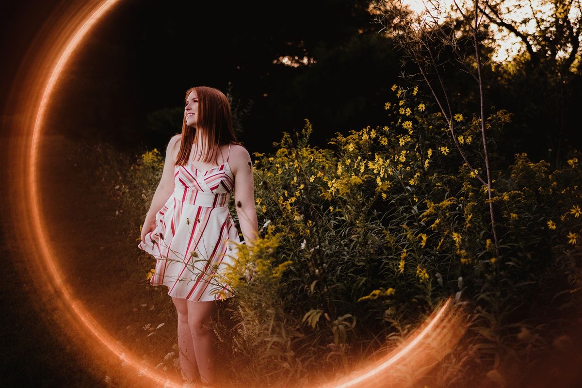 Ethereal portrait with decorative glowing crescent moon effect in evening light.