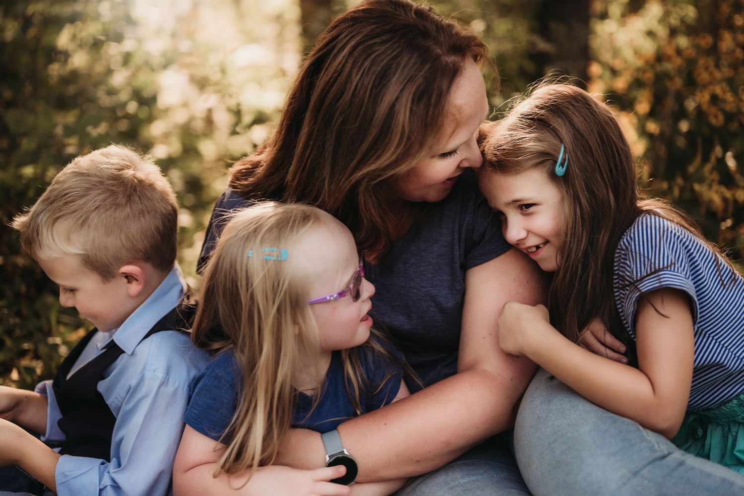 Tender family moment captured outdoors with warm natural lighting.