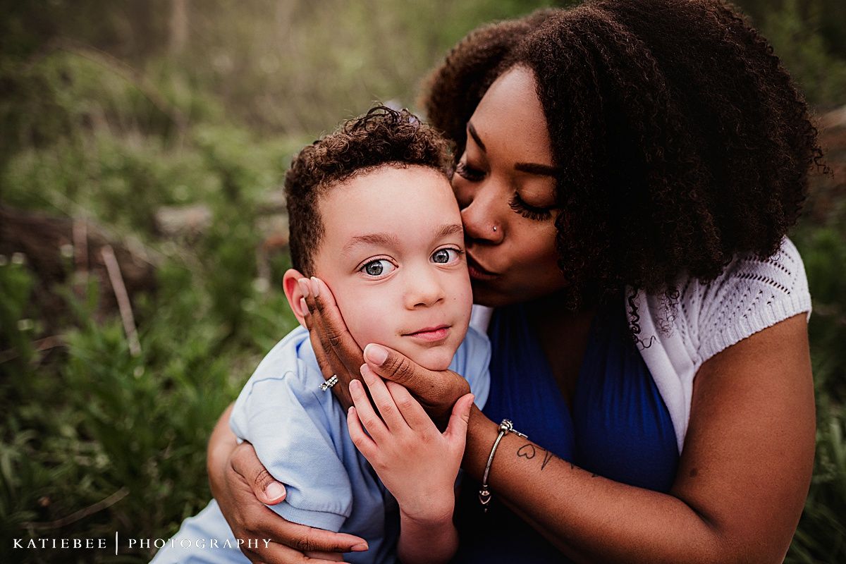 Tender moment between mother and child during an outdoor portrait session.