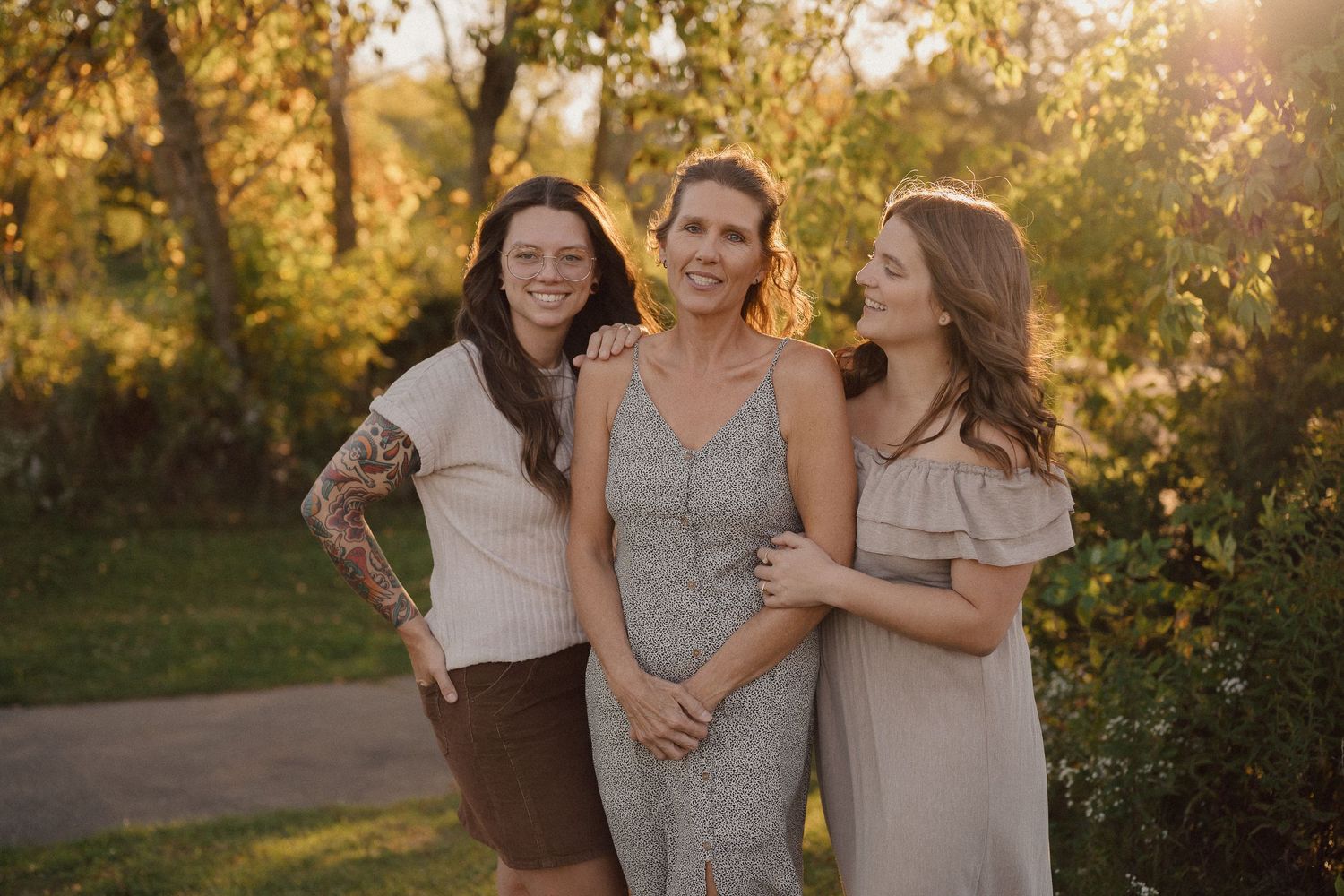 Casual outdoor group photo with natural lighting and autumn foliage in background.