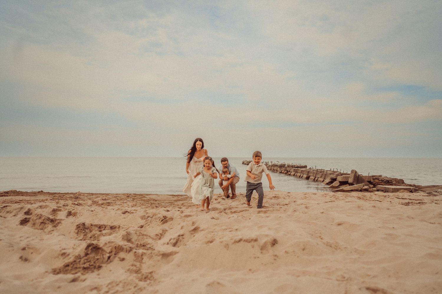 A group enjoys a sunset moment while walking along the beach together.