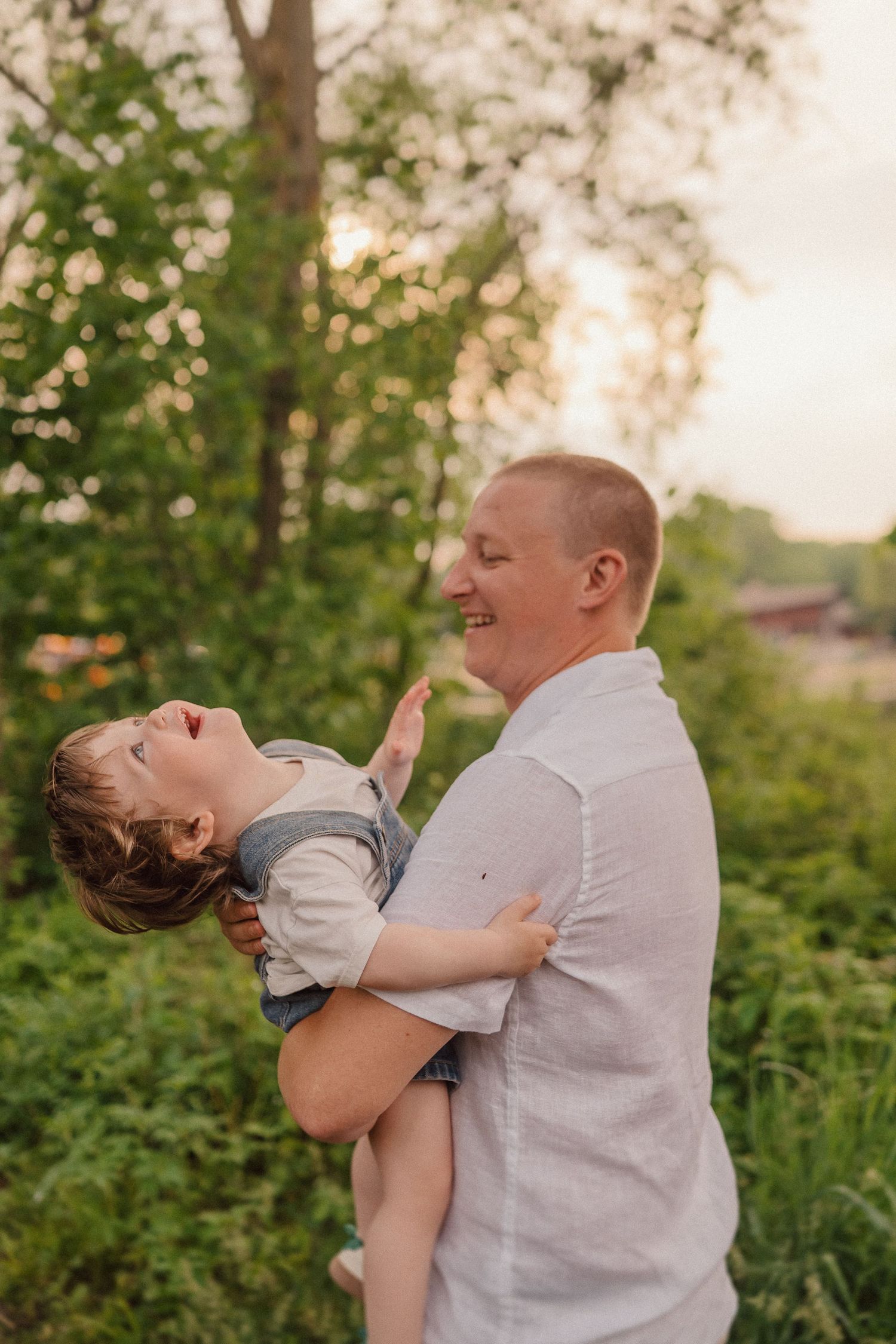 A joyful moment captured between parent and child playing outdoors at sunset.