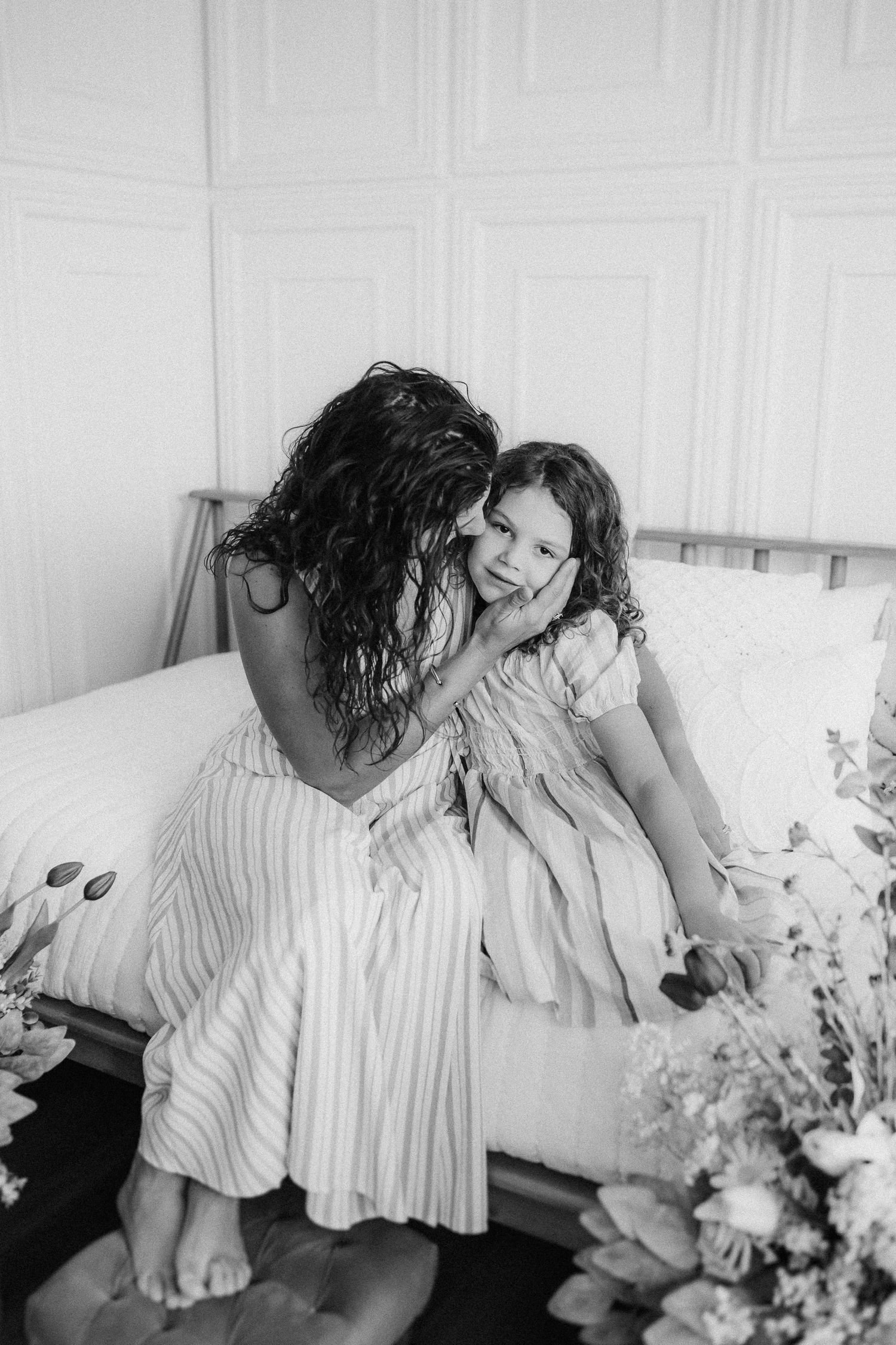 Black and white candid photography of tender moment on wooden bench.