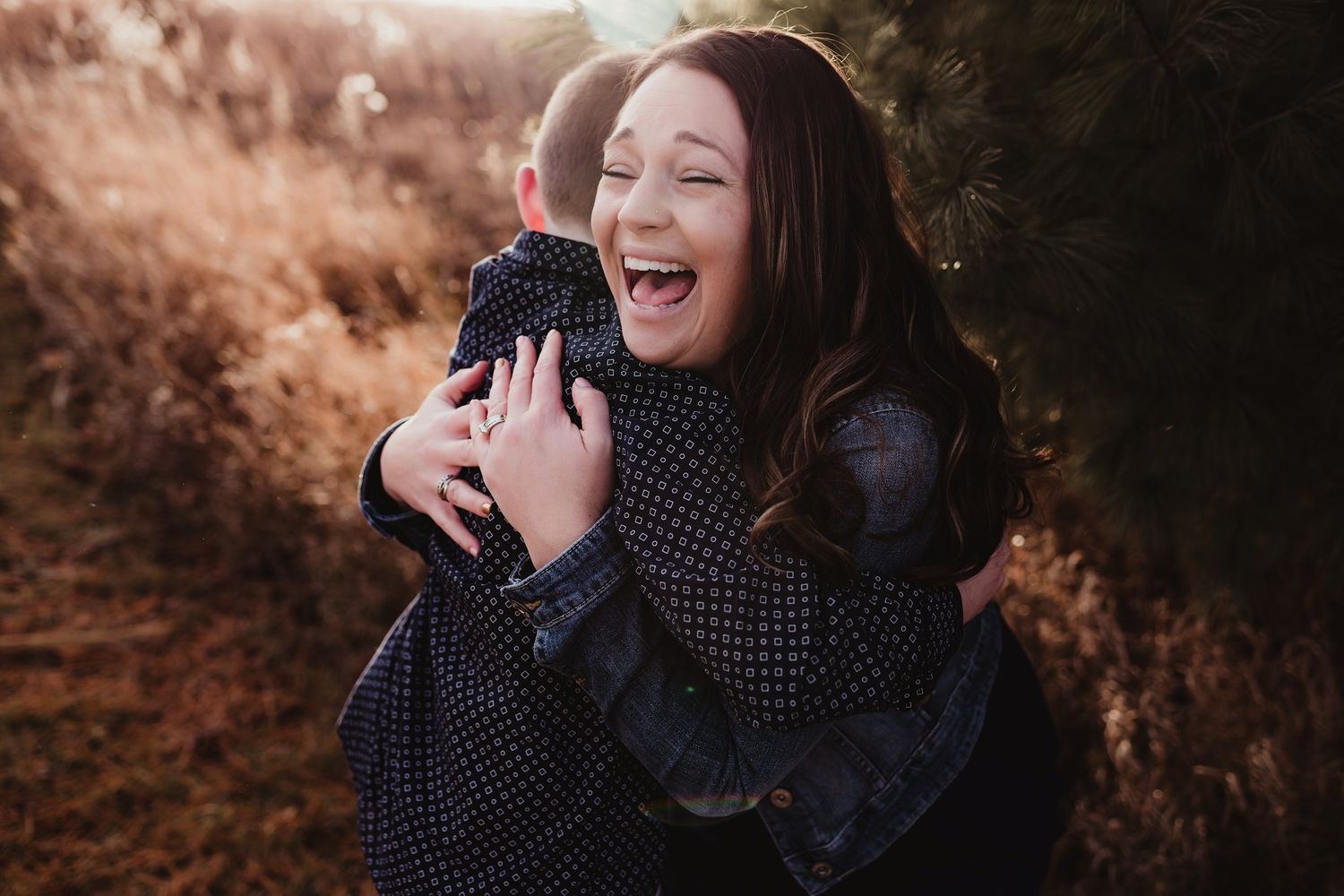 A candid moment of pure laughter and happiness captured in warm lighting.