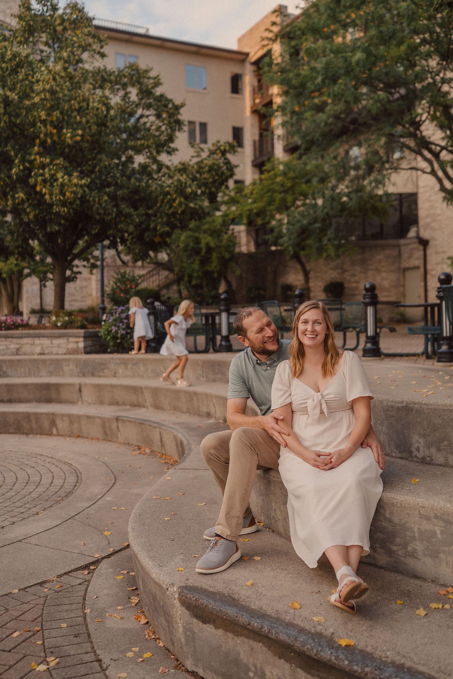 A series of candid moments captured on stone steps during golden hour.