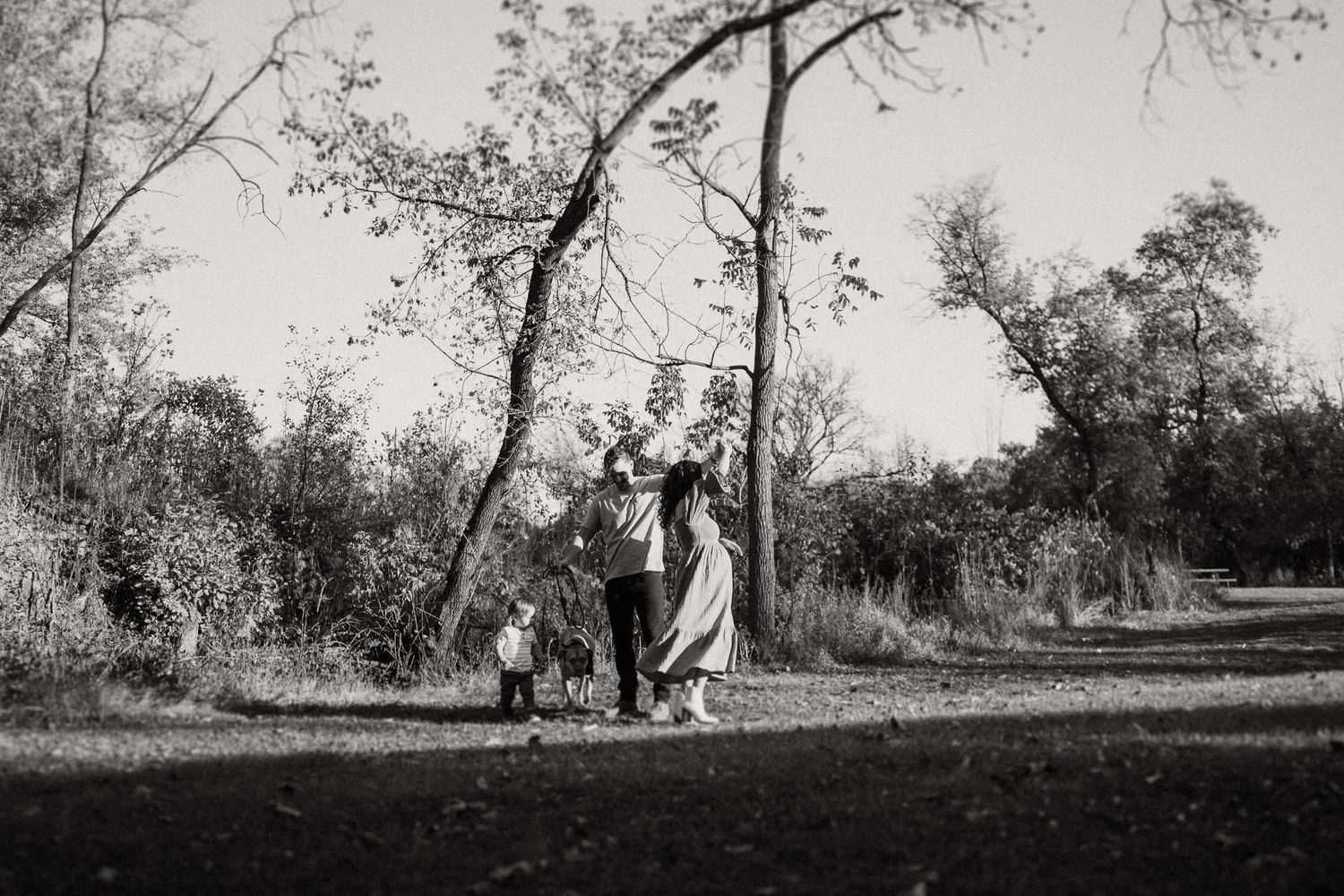 Vintage-style black and white image of family enjoying outdoor playtime together.
