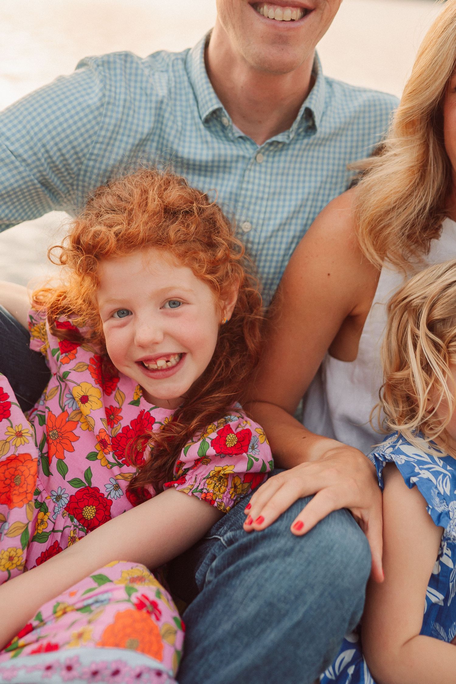 A candid family moment captured with bright floral patterns and warm smiles.