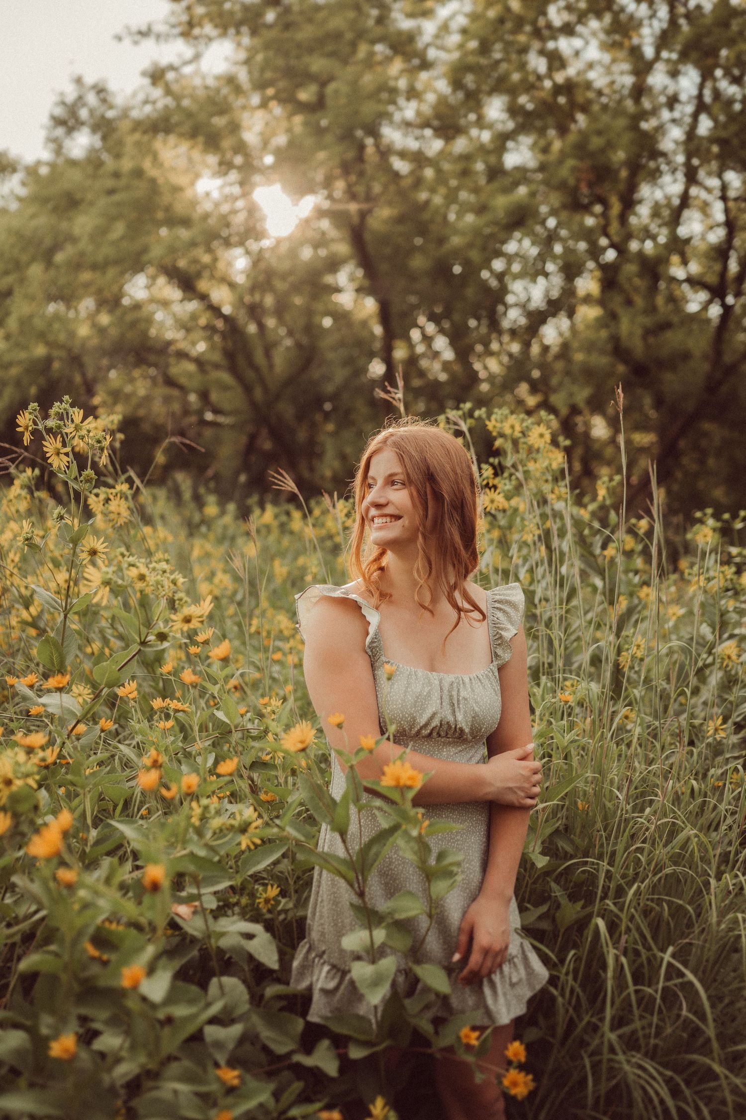 Sunset garden portrait with orange flowers and a grey ruffle dress.