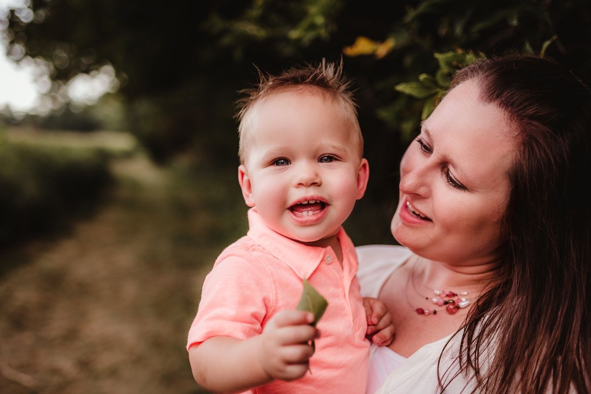 Candid close-up portrait of happy family moment outdoors in natural lighting.