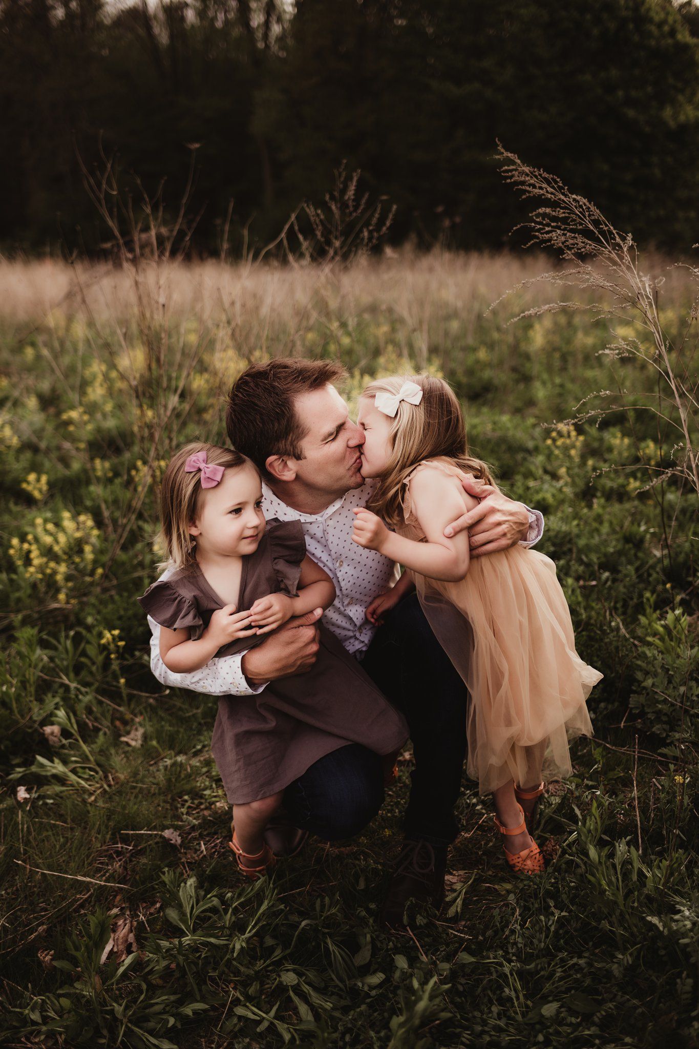 Sweet family moment captured in a wildflower field during golden hour.