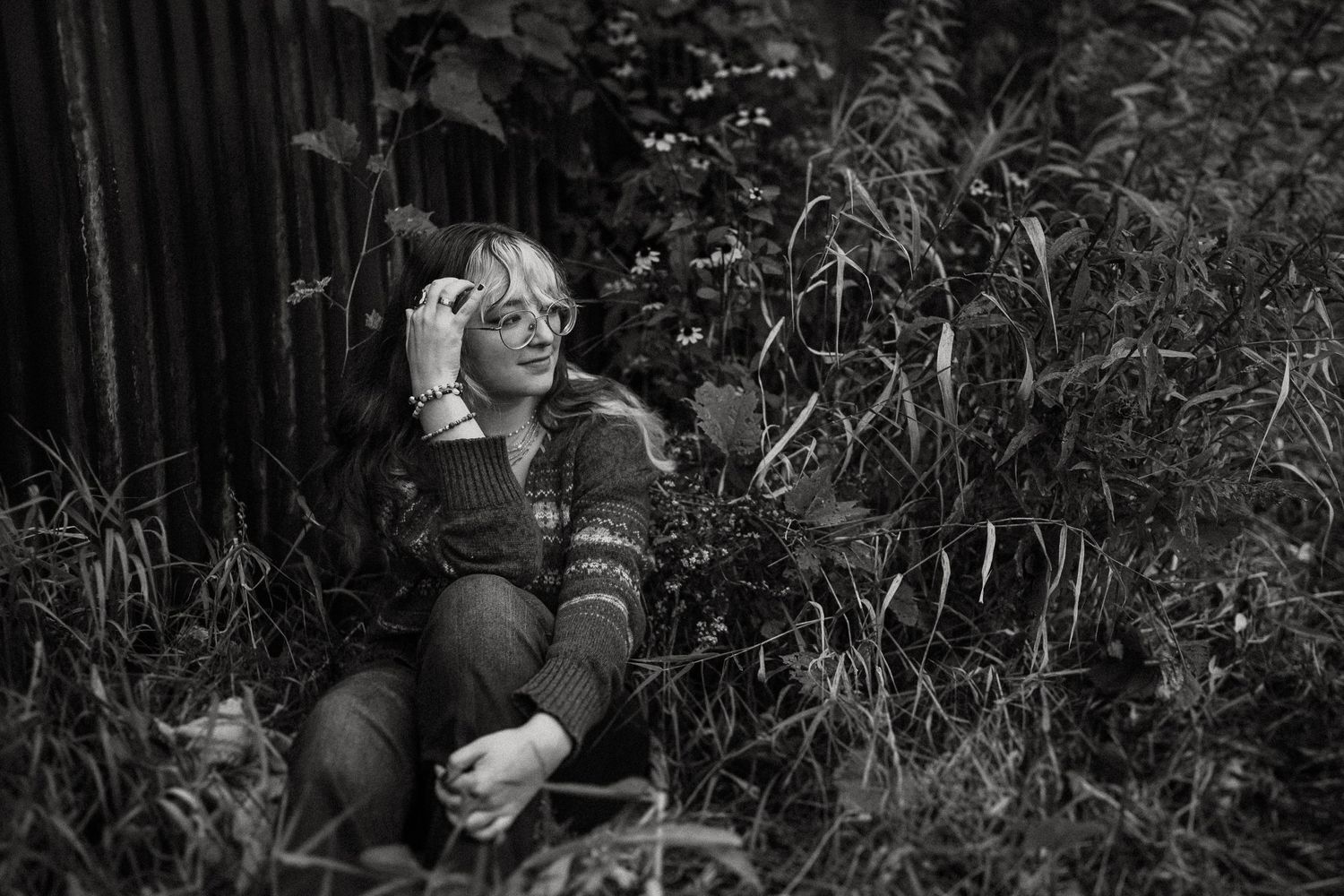 A relaxed black and white portrait amongst wild grasses and natural scenery.