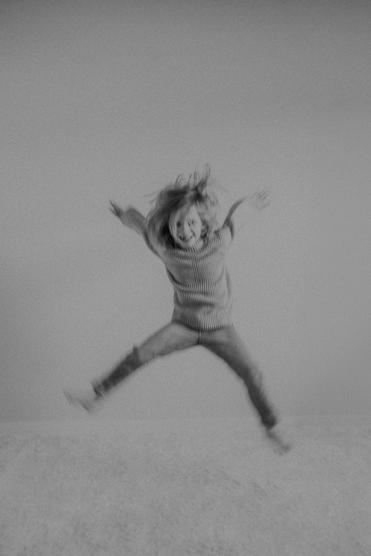 Blurred action shot in black and white showing mid-jump excitement.