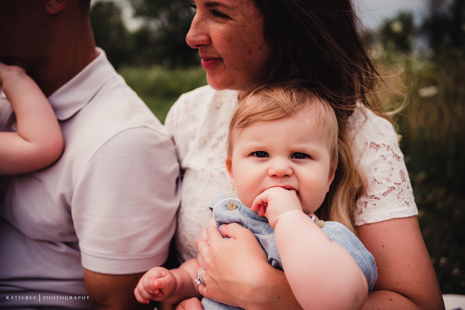 A close-up candid moment of a family enjoying time together outdoors.