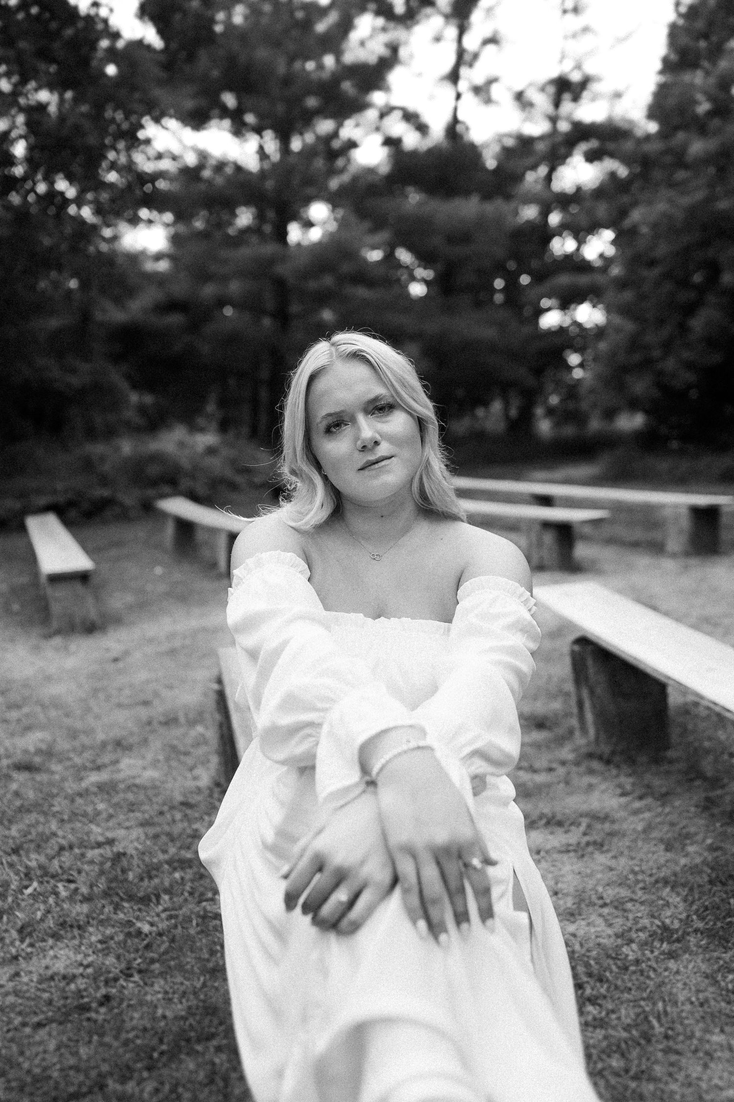 Black and white portrait series on a wooden bench showcasing artistic angles and expressions.