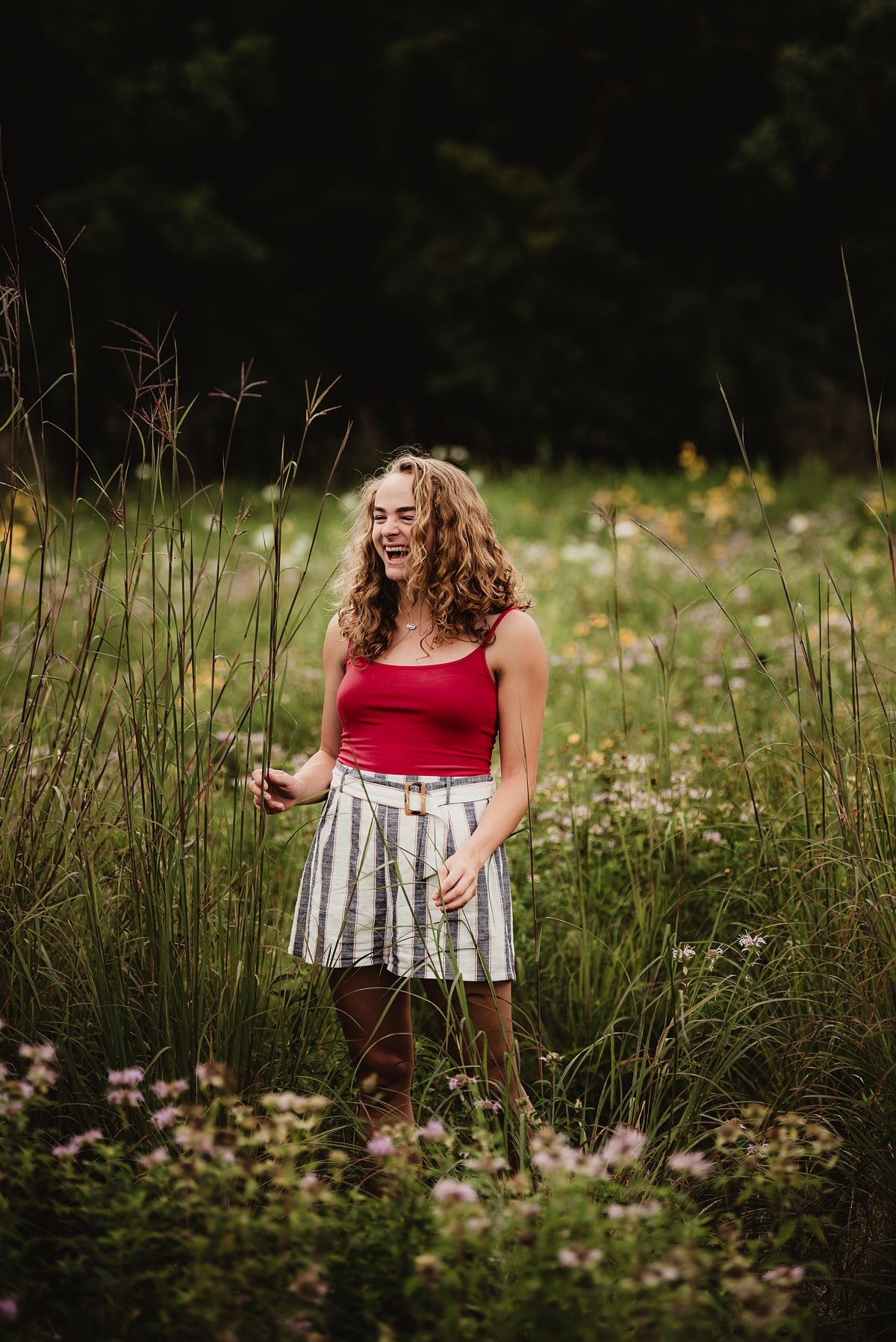 Candid outdoor photo in a wildflower field with summer fashion and natural lighting.