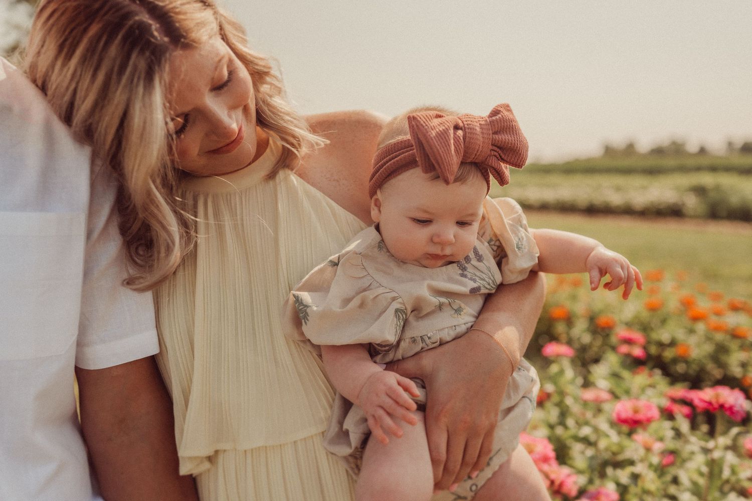 Close-up portrait of a family sharing an intimate moment among blooming flowers.