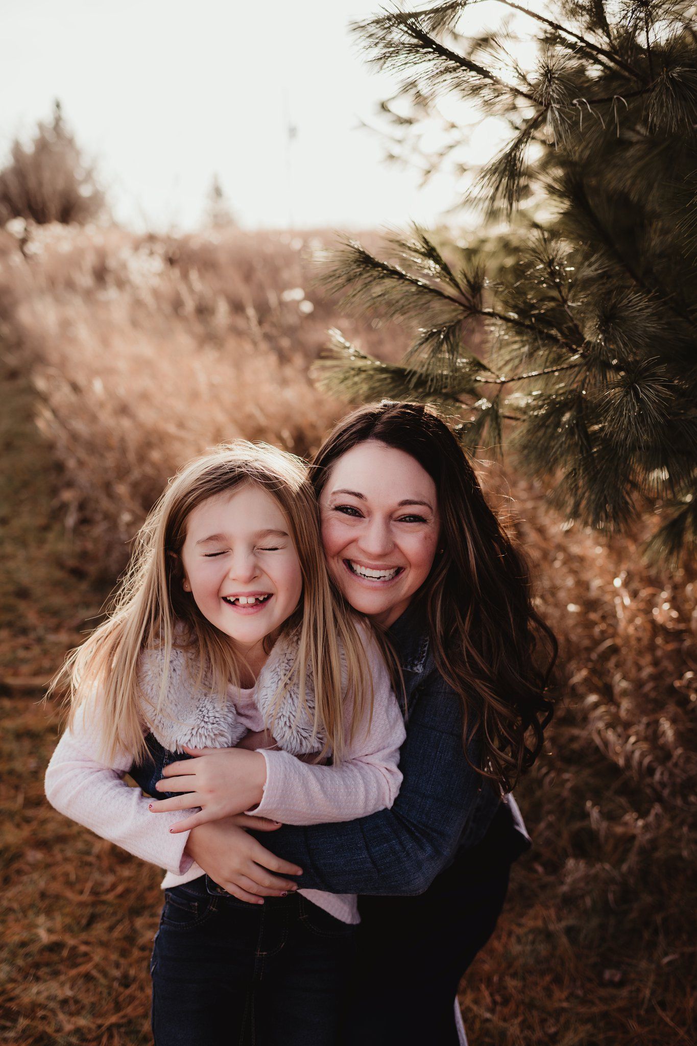 Heartwarming embrace captured in natural lighting against autumn foliage.