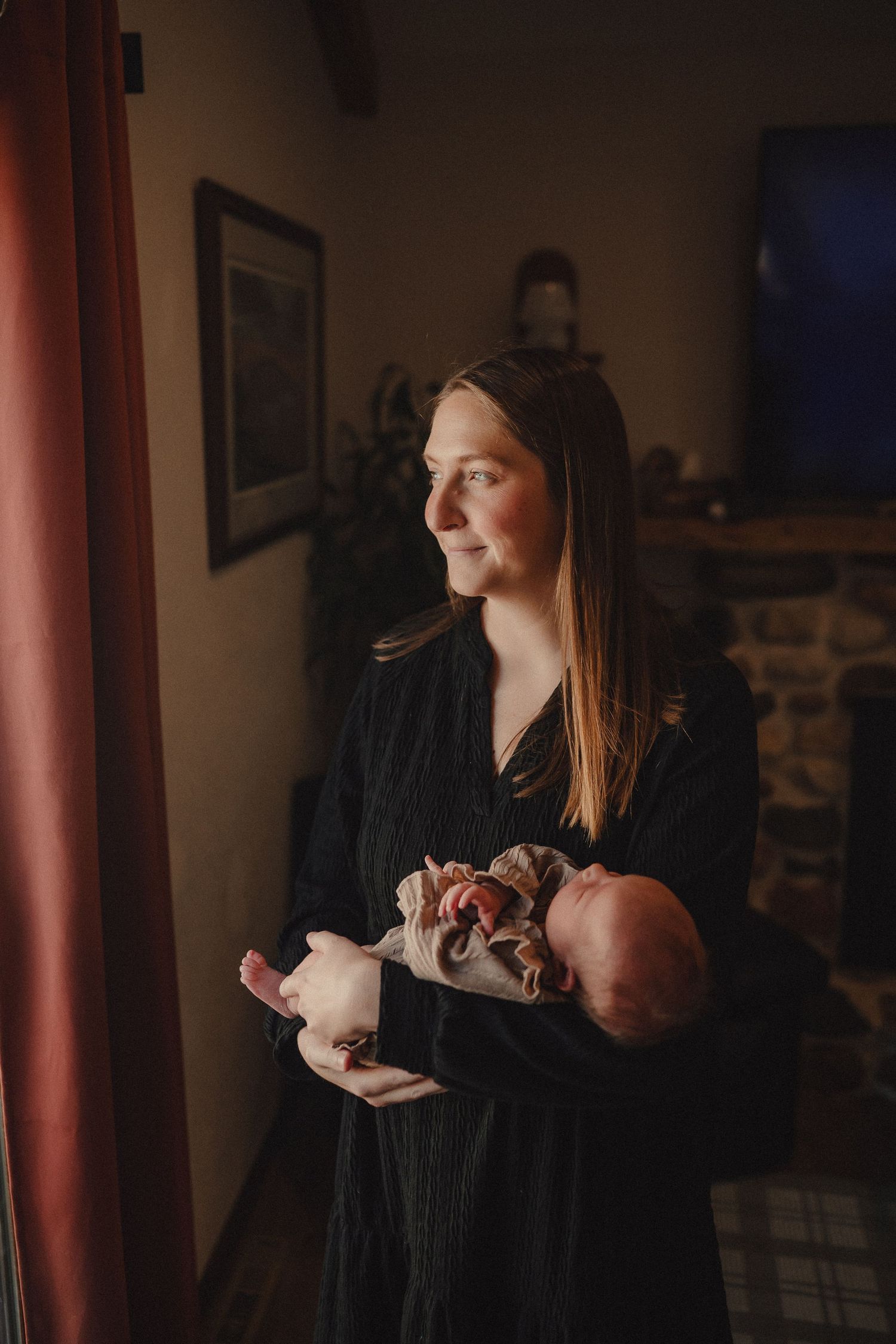 A series of intimate family moments captured in moody lighting showing tender interactions and embraces.