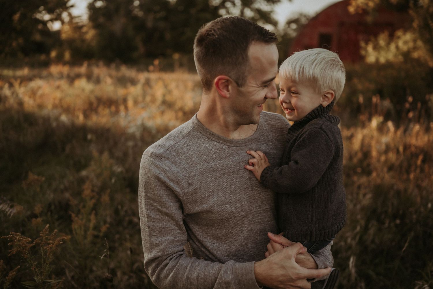 A tender moment shared between parent and child during golden hour outdoors.