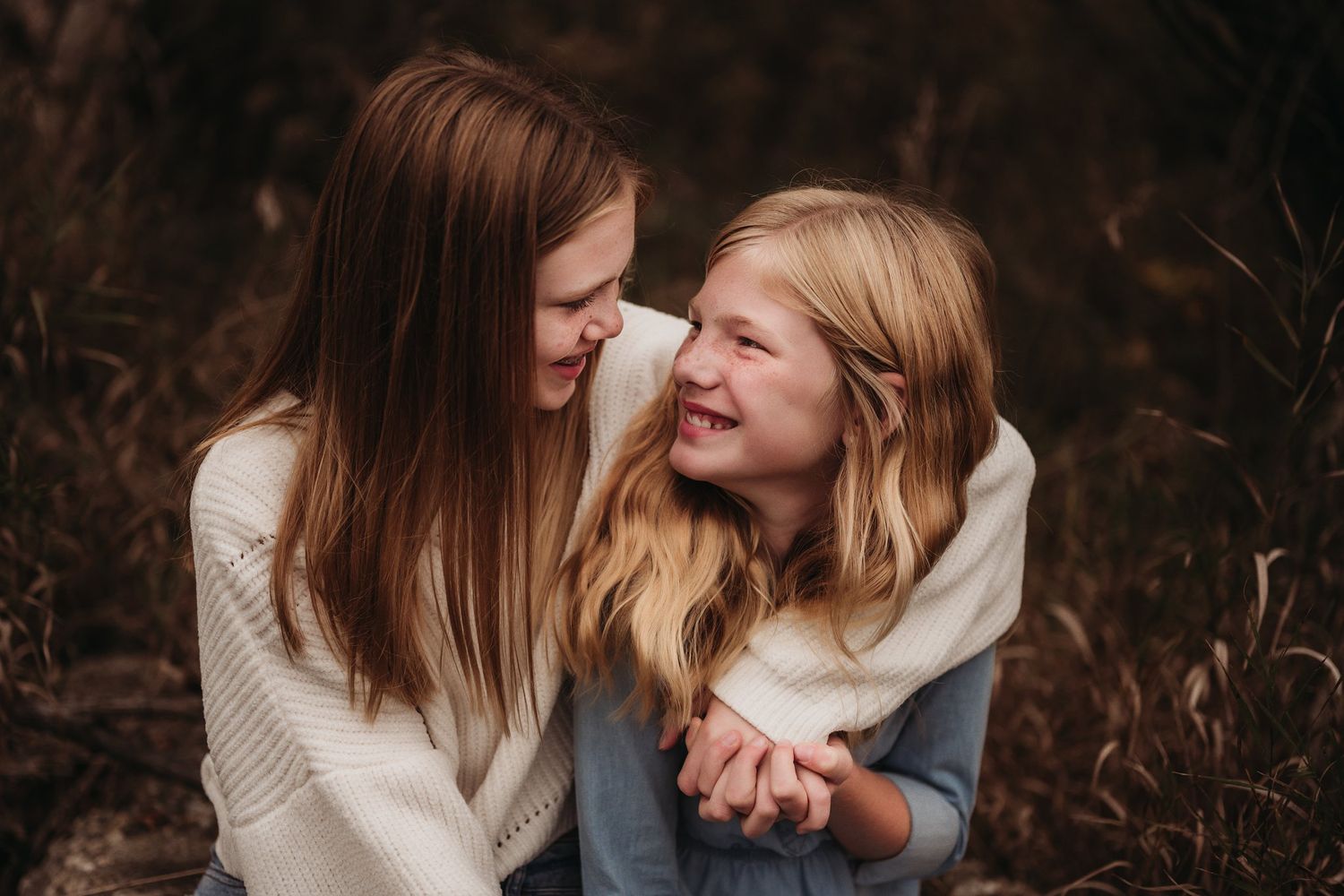 Close candid moment of shared joy between two people in autumn setting.