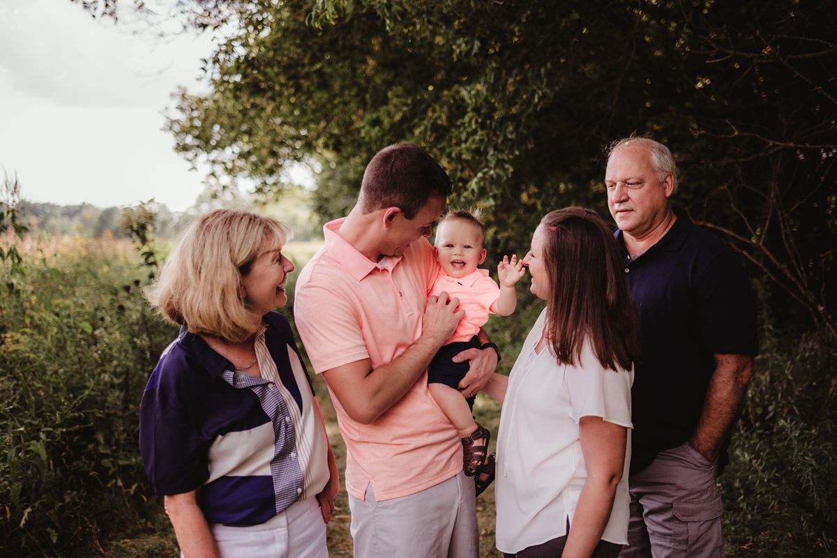 A casual family gathering in a natural outdoor setting during sunset.