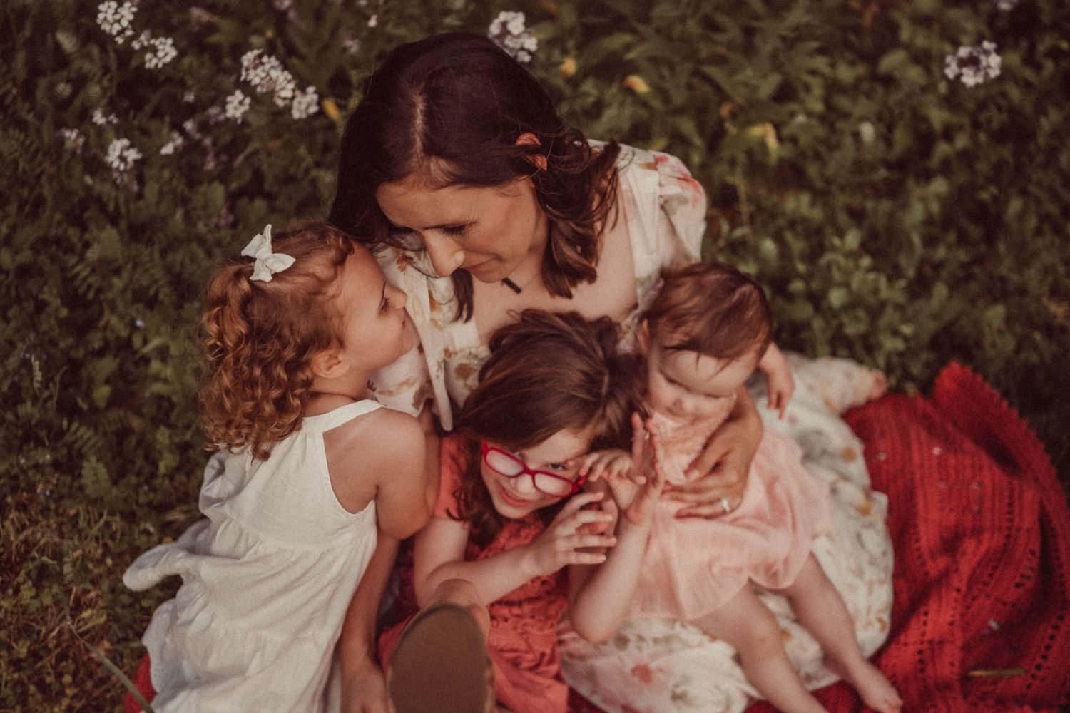 A heartwarming family moment captured outdoors with casual embraces and laughter.