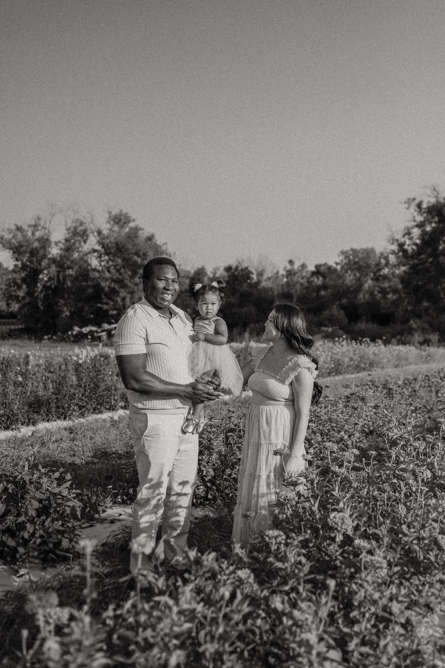 A family shares a special moment together in a blooming wildflower field.