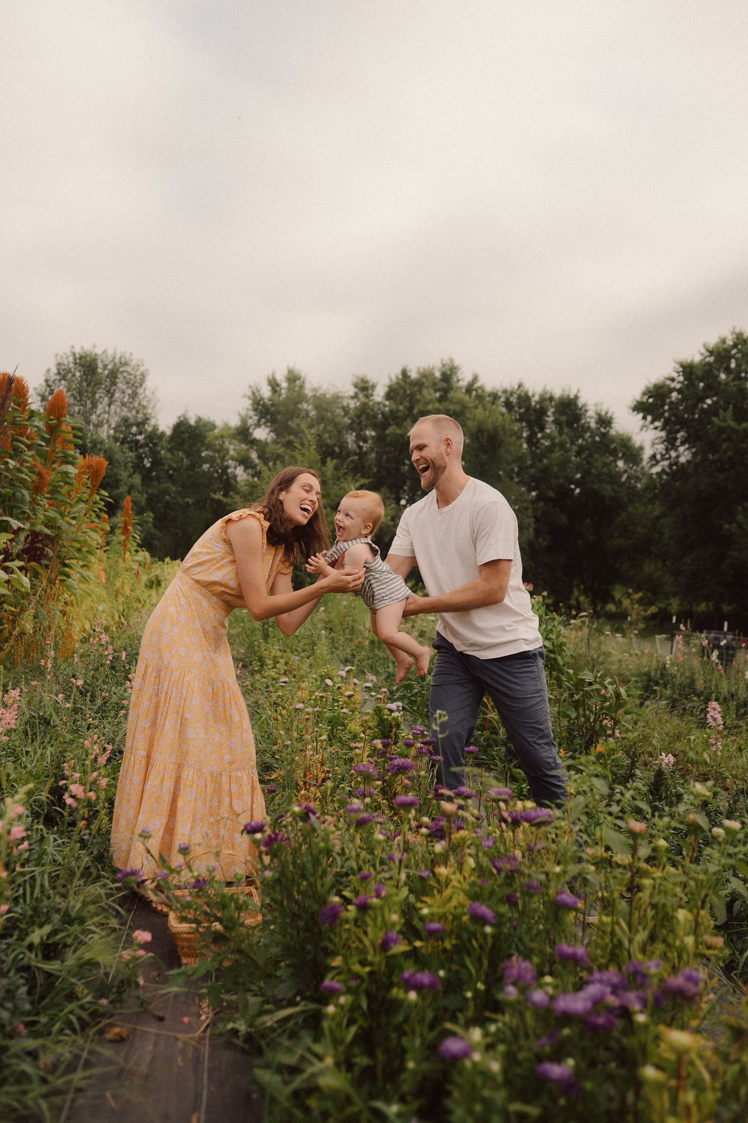 Joyful interactions in a blooming flower garden with purple and orange wildflowers.