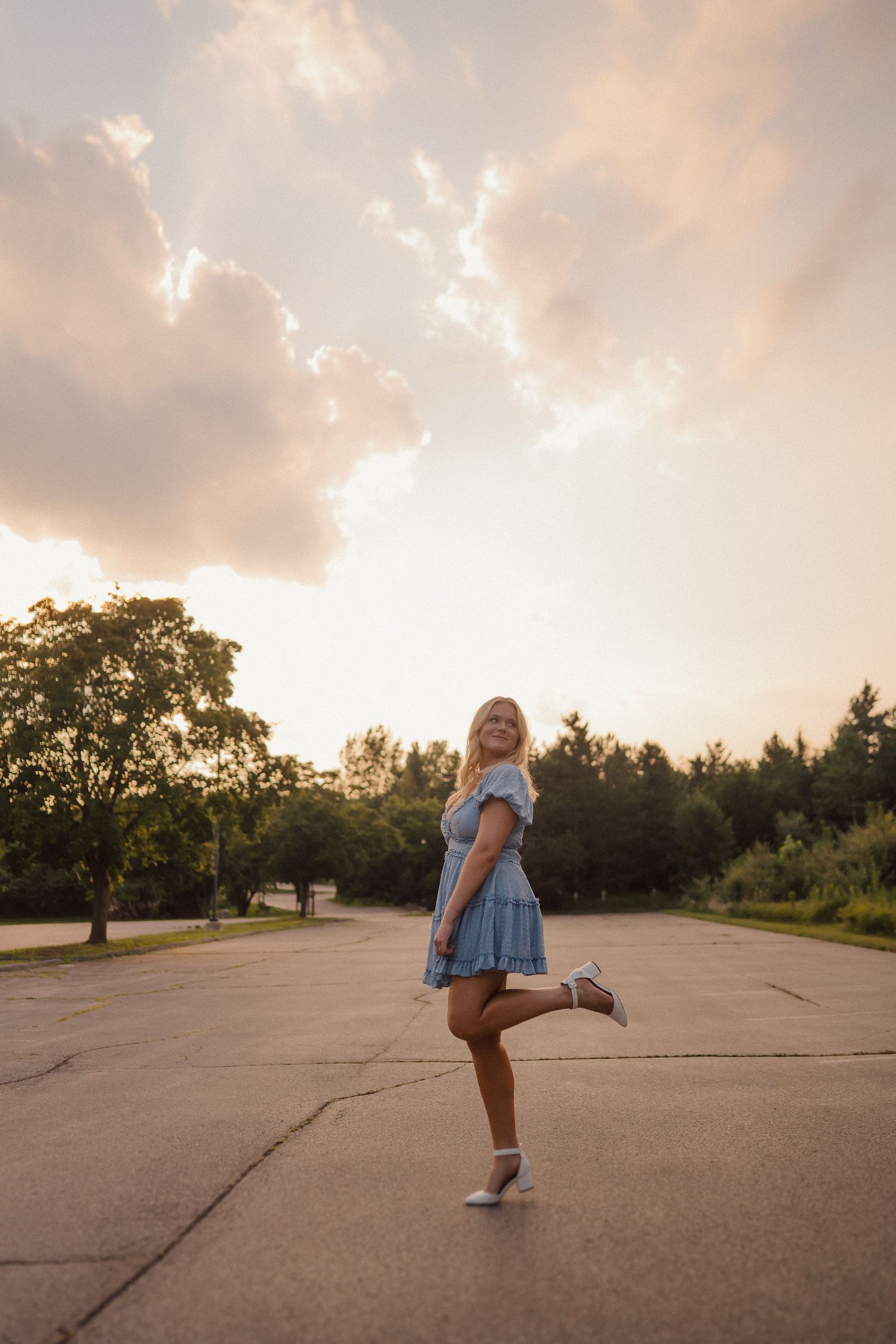 Figure dances playfully on concrete during golden sunset.