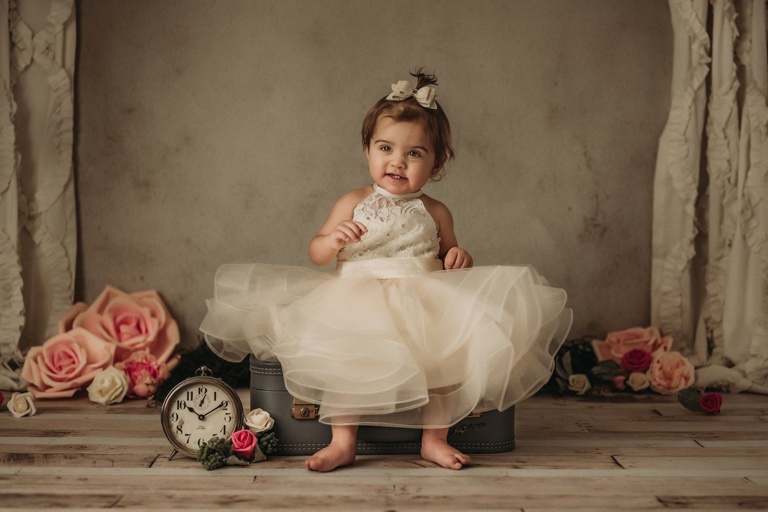 Vintage-styled portrait with pink roses and antique clock as props.